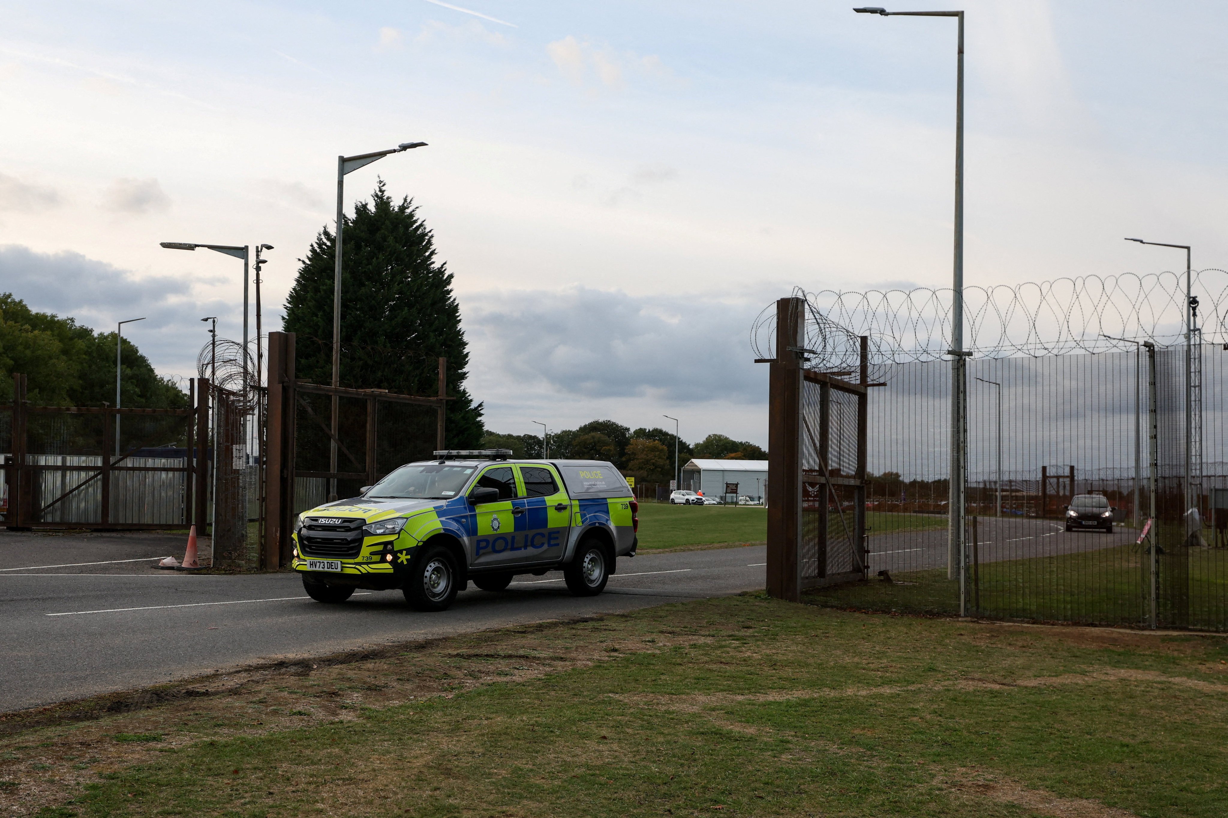 A police car leaves RAF Molesworth after two Latvian nationals were arrested. Photo: Reuters