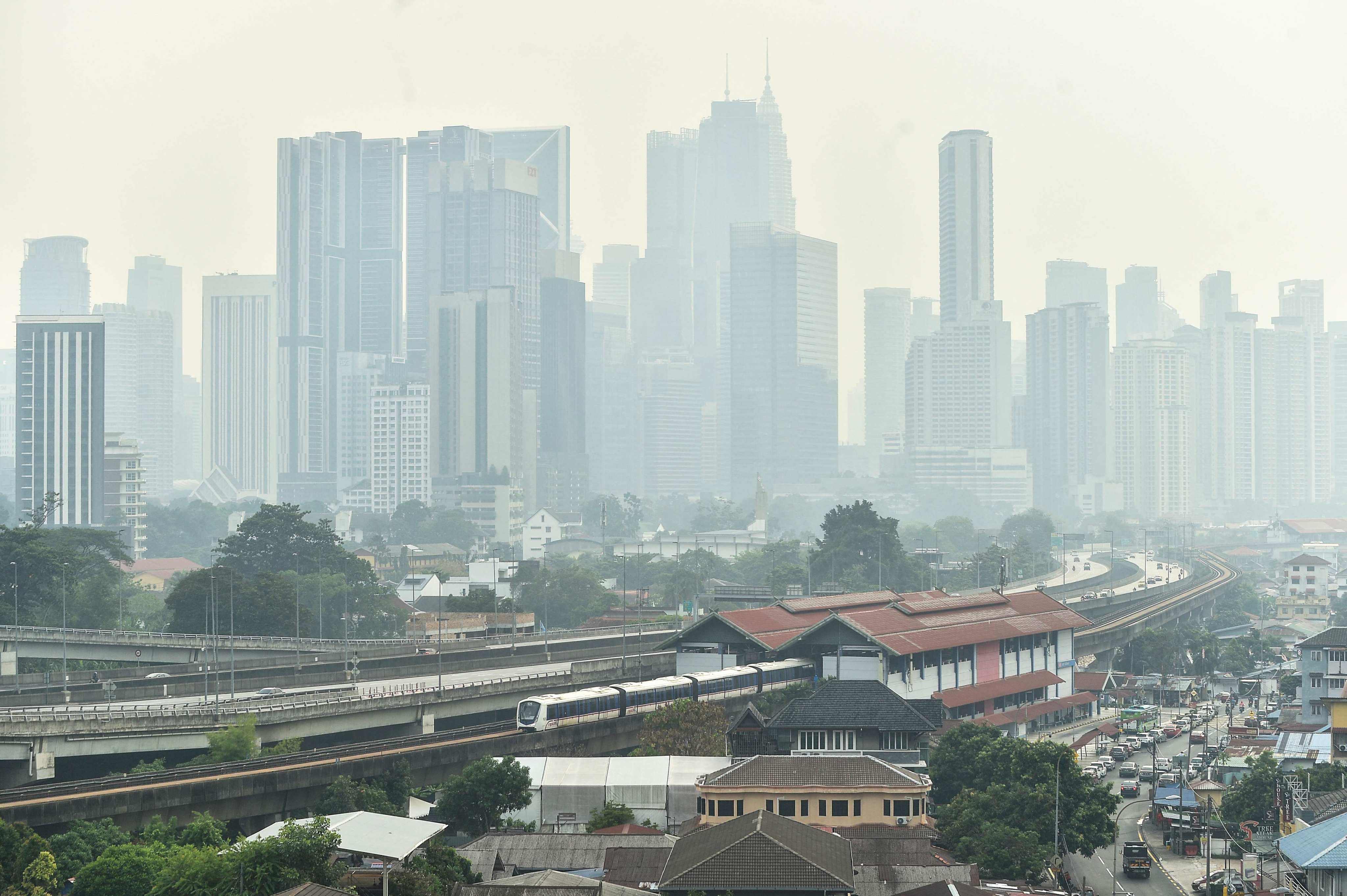A dense layer of haze blankets the Kuala Lumpur skyline in Malaysia on Wednesday. Photo: AFP