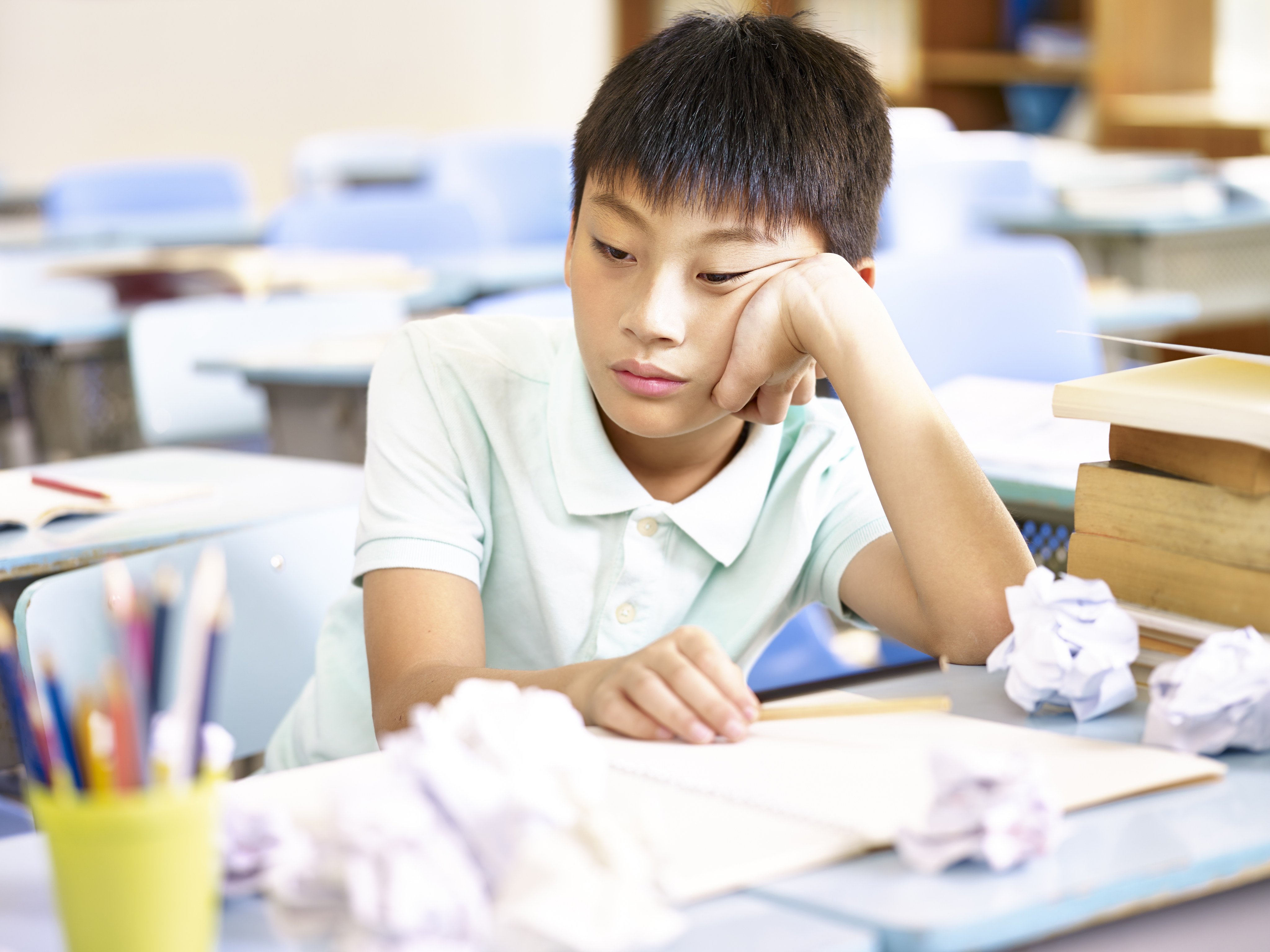 A student sits at a desk during a class. Academic pressure and long studying hours are a major source of stress for youth across Asia. Photo: Shutterstock