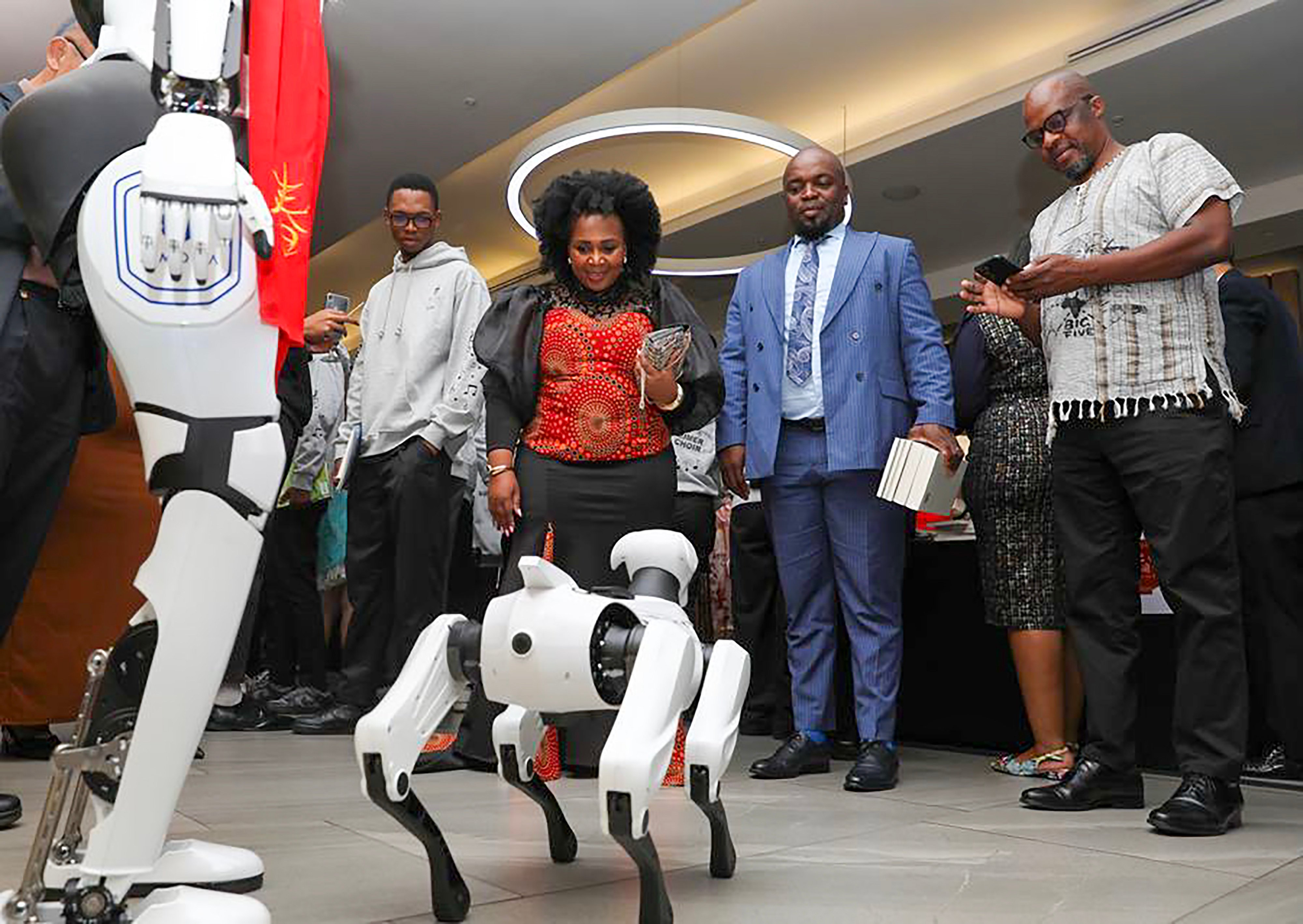 Guests interact with a robot dog during an event to celebrate Chinese New Year in Johannesburg, South Africa in February. Photo: Xinhua