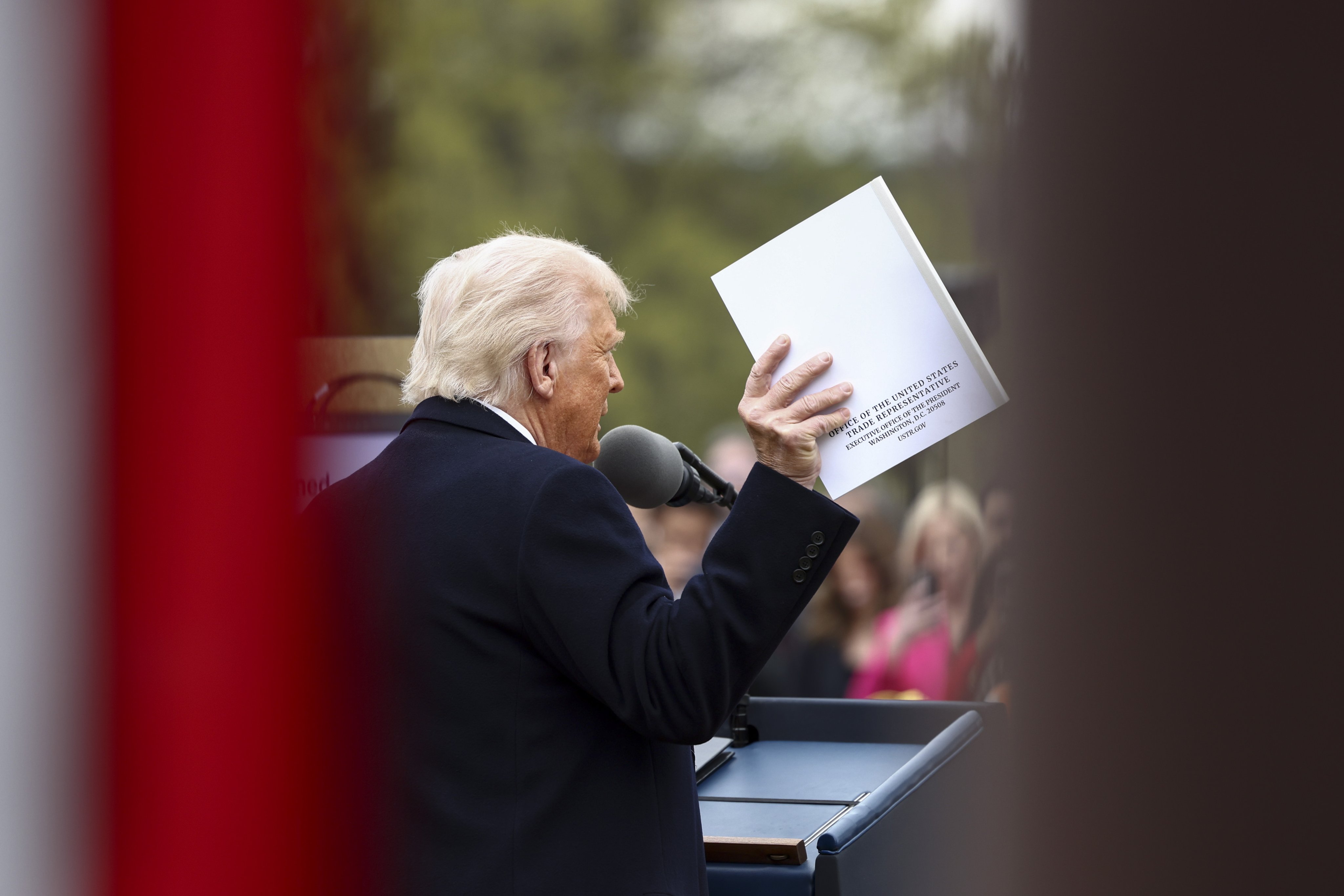US President Donald Trump holds up a document from the Office of the United States Trade Representative as he announces reciprocal tariffs against US trading partners, in the Rose Garden of the White House in Washington, on April 2, 2025. Photo: EPA-EFE