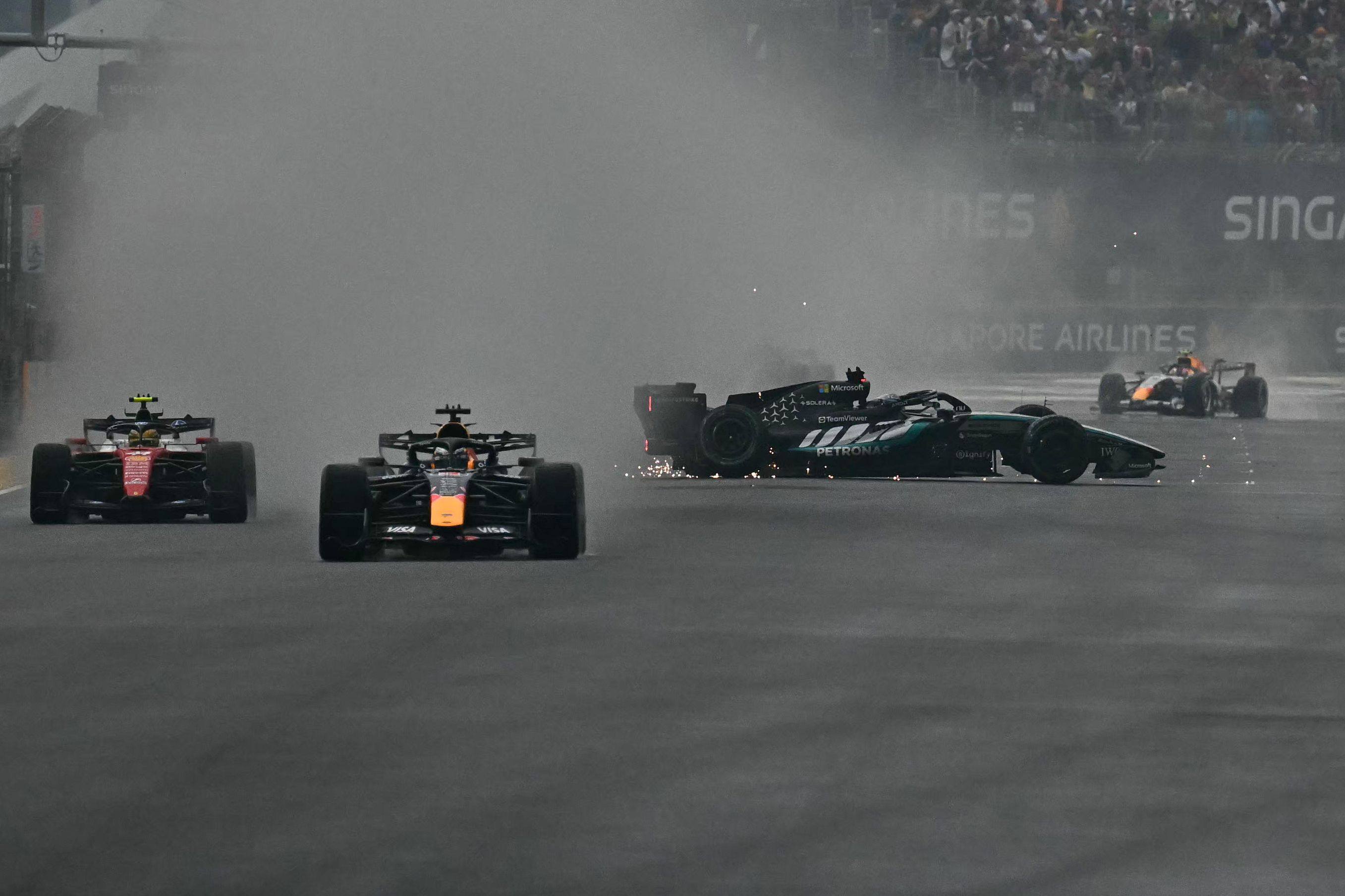 Mercedes’ George Russell (second from right) crashes as Ferrari’s Lewis Hamilton (left) and Red Bull’s Max Verstappen steer past during the sprint race on Saturday. Photo: AFP