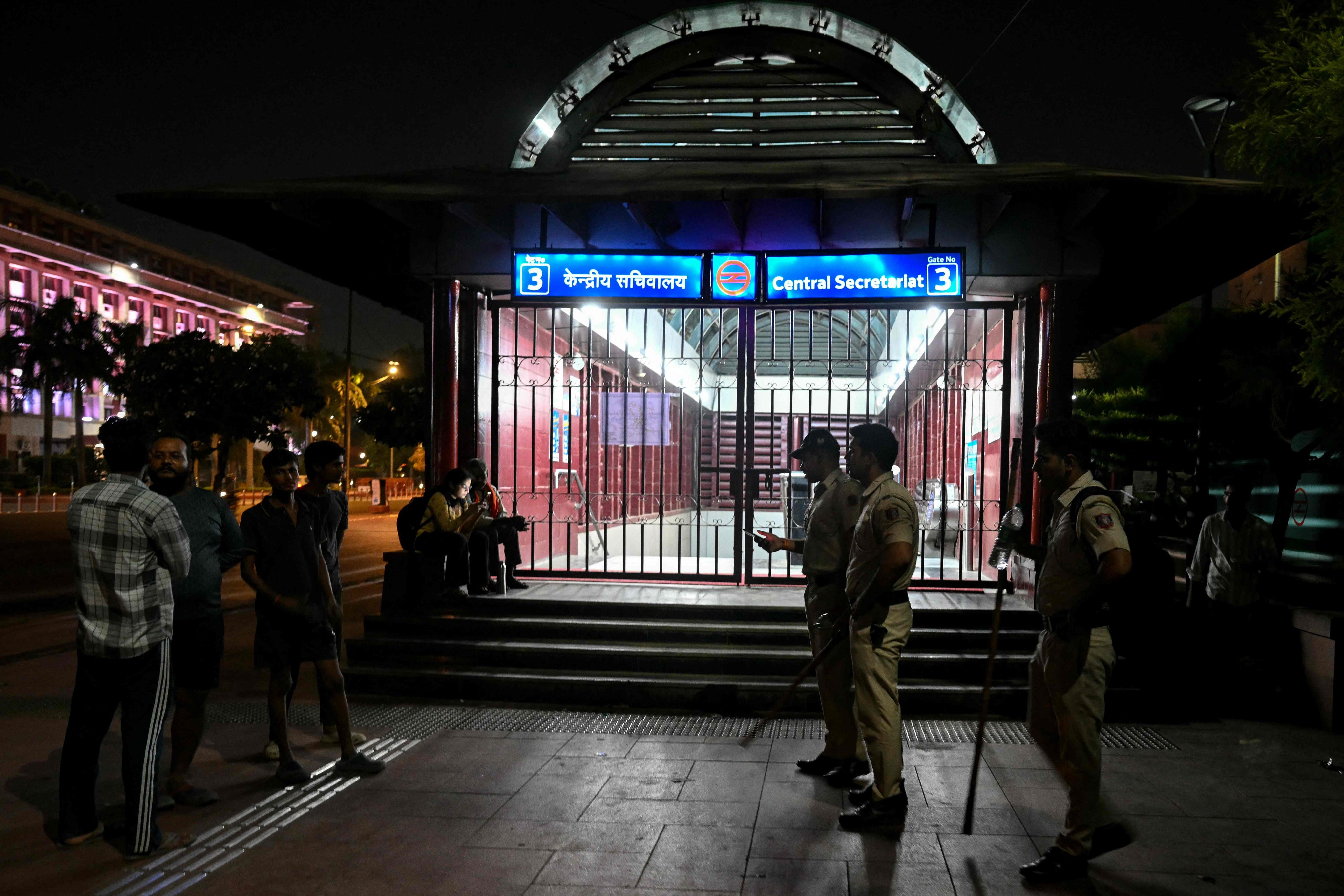 Police officers guard a closed metro station in New Delhi, India, on Friday, ahead of planned political protests. Photo: AFP