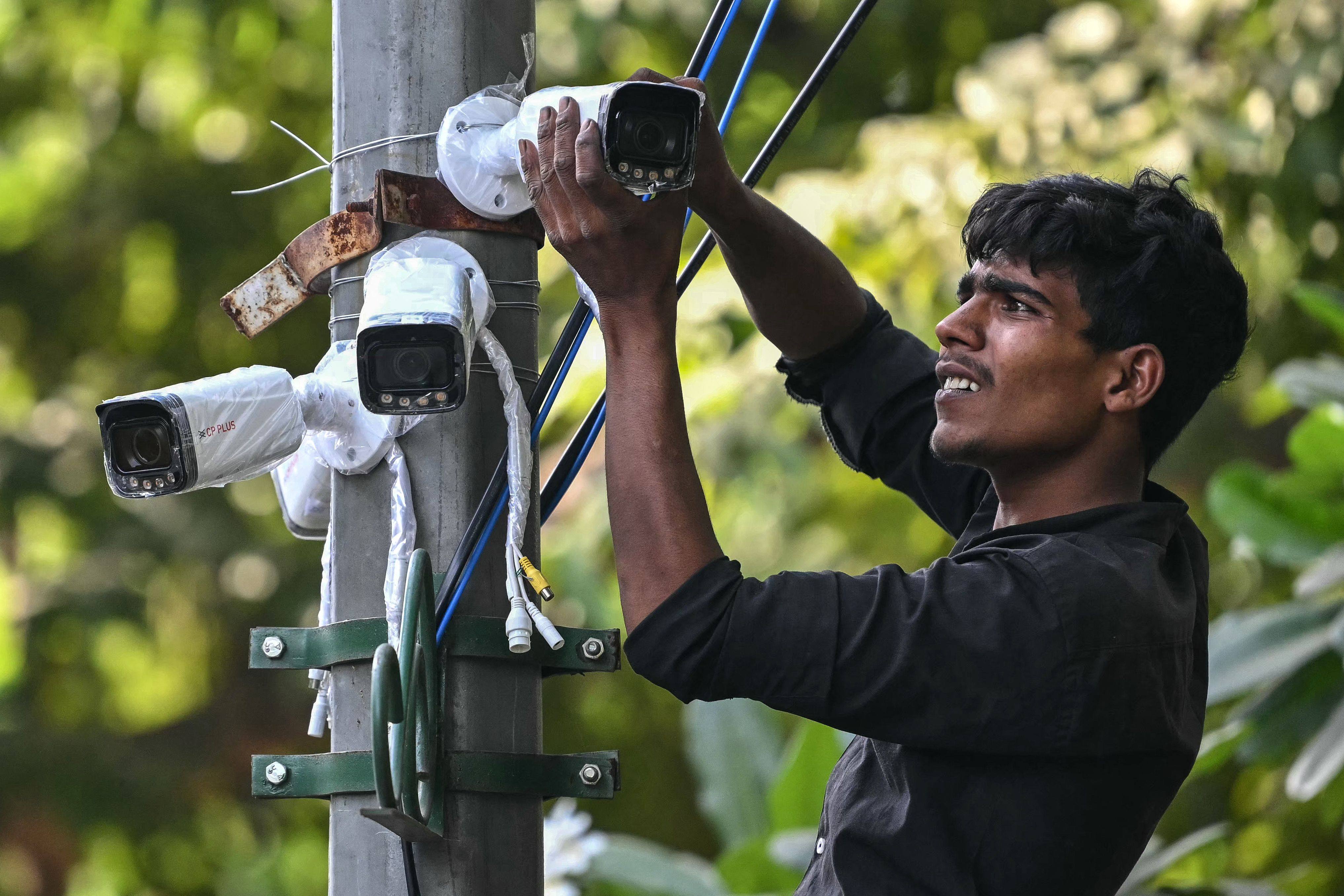 A worker installs CCTV surveillance cameras near Jantar Mantar in New Delhi, India, on Friday, ahead of planned political protests. Photo: AFP