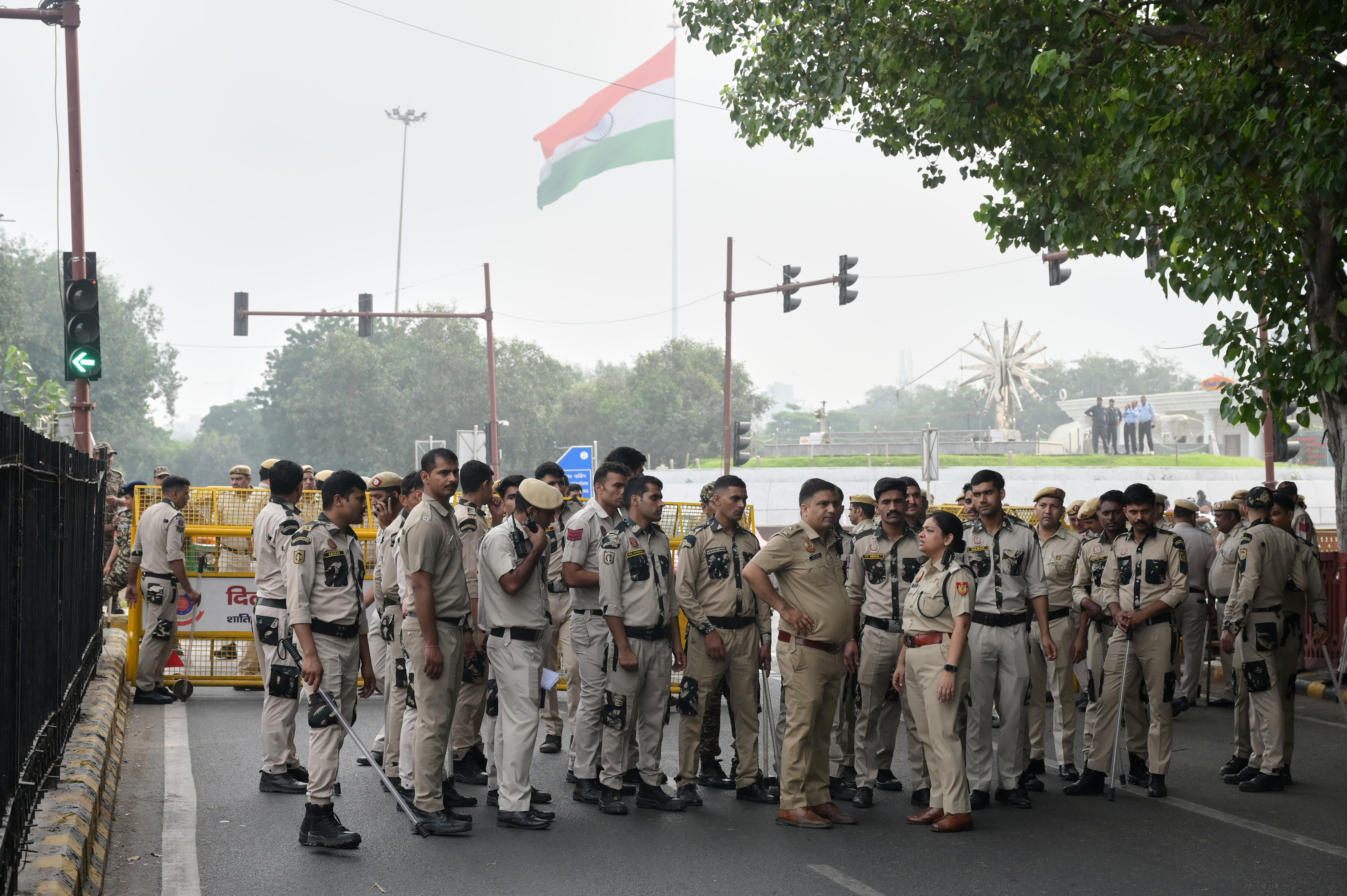 Delhi police officers stand guard near street barricades in India on Saturday. Photo: AP
