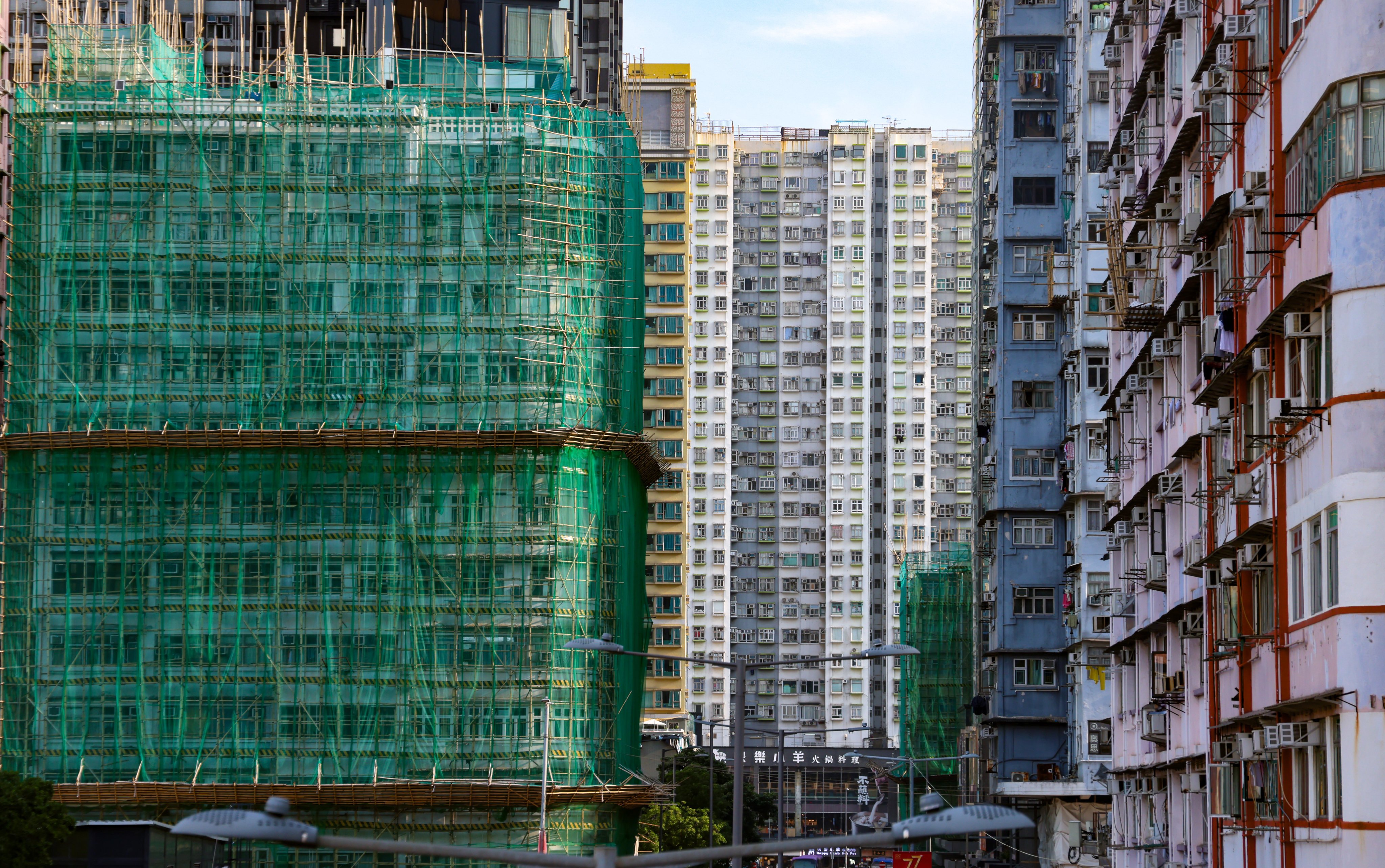 Bamboo scaffolding and protective netting cover older residential blocks undergoing repair work in Mong Kok. Photo: Silvia Siu
