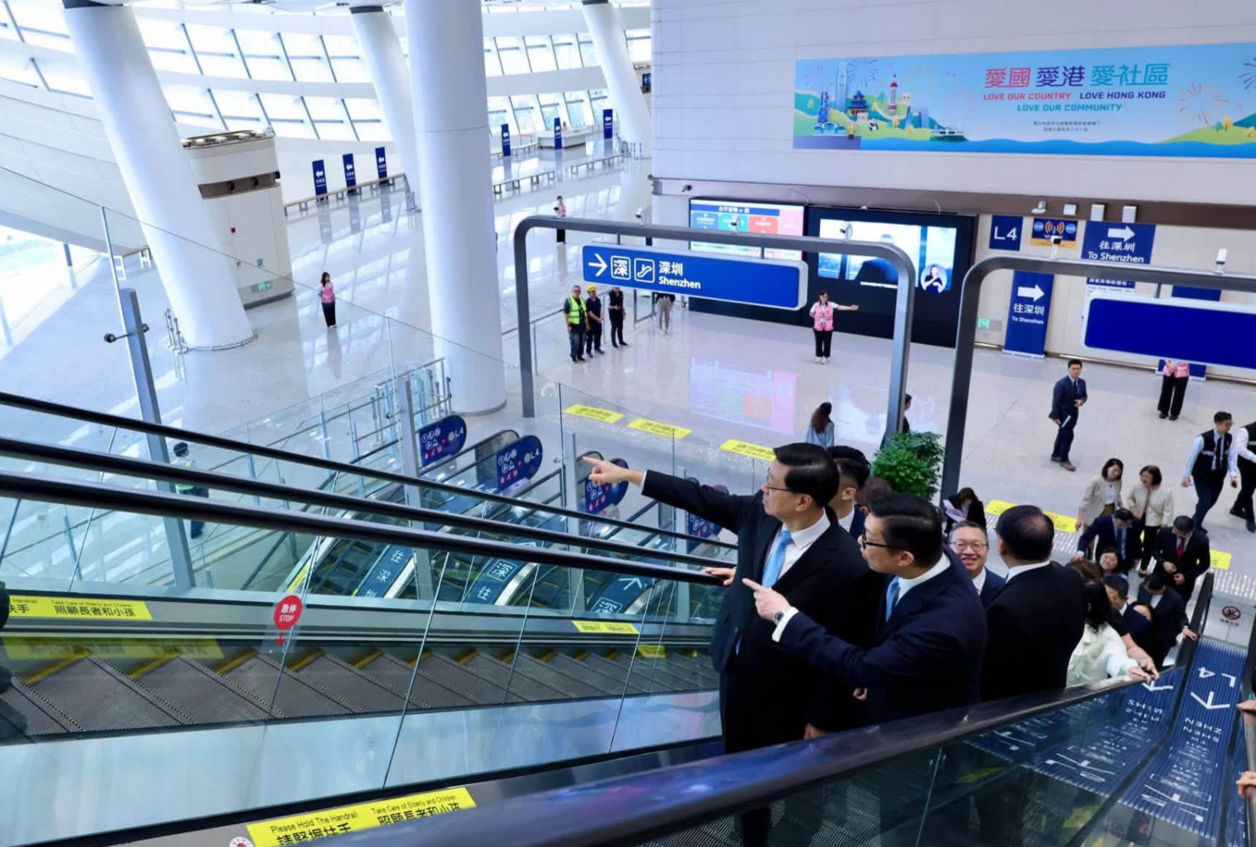 Chief Executive John Lee and other officials on an escalator in Huanggang Port on Sunday. Photo: Handout