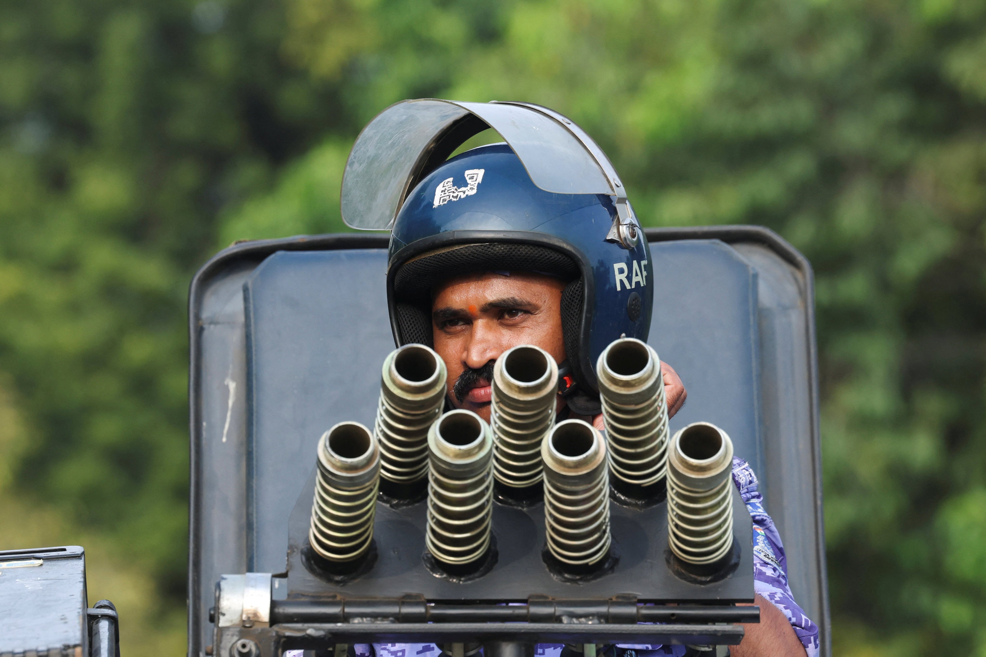 A security officer positions himself on a riot control vehicle in New Delhi on Sunday. Photo: Reuters