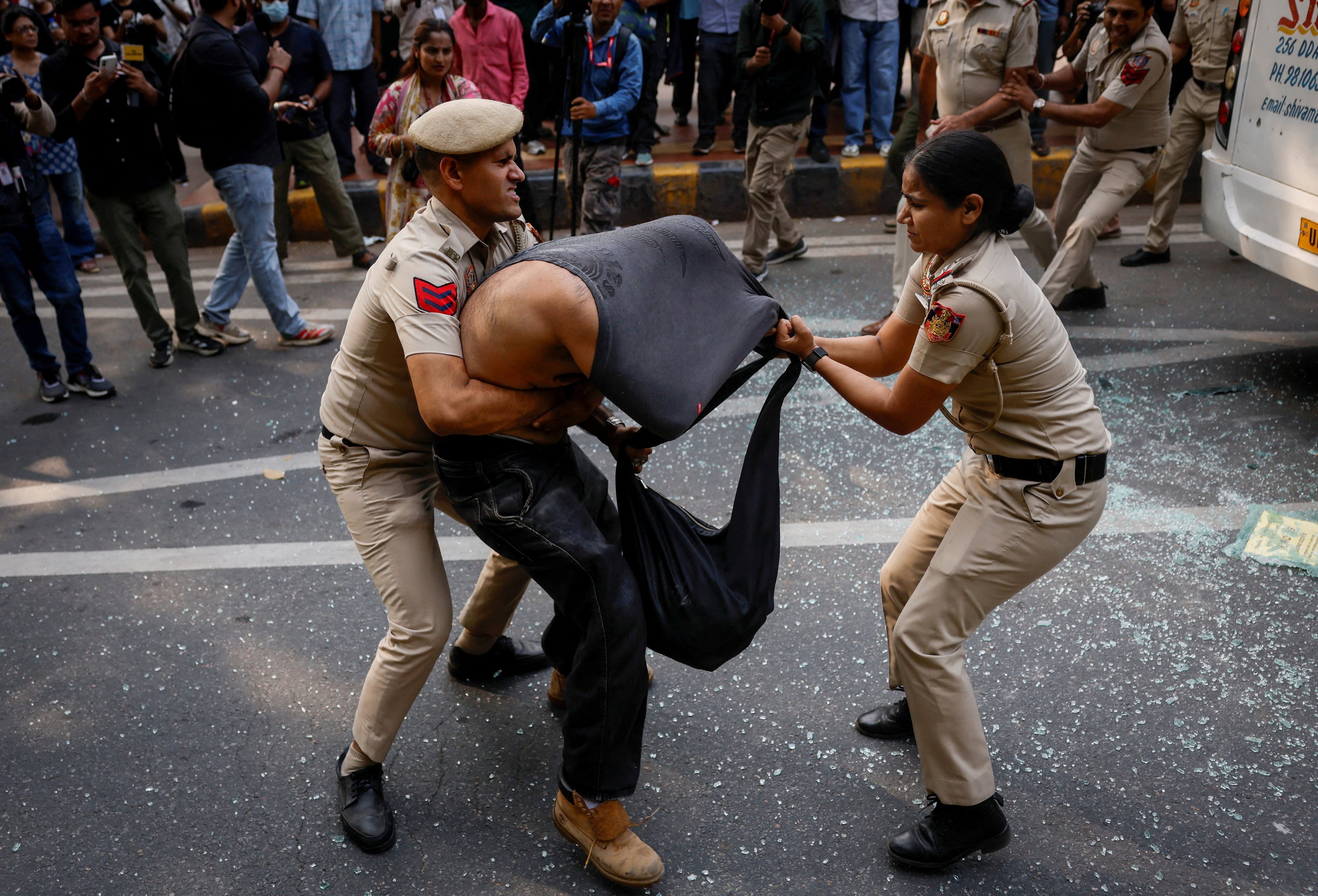Security personnel detain a protester in New Delhi, India, on Saturday. Photo: Reuters