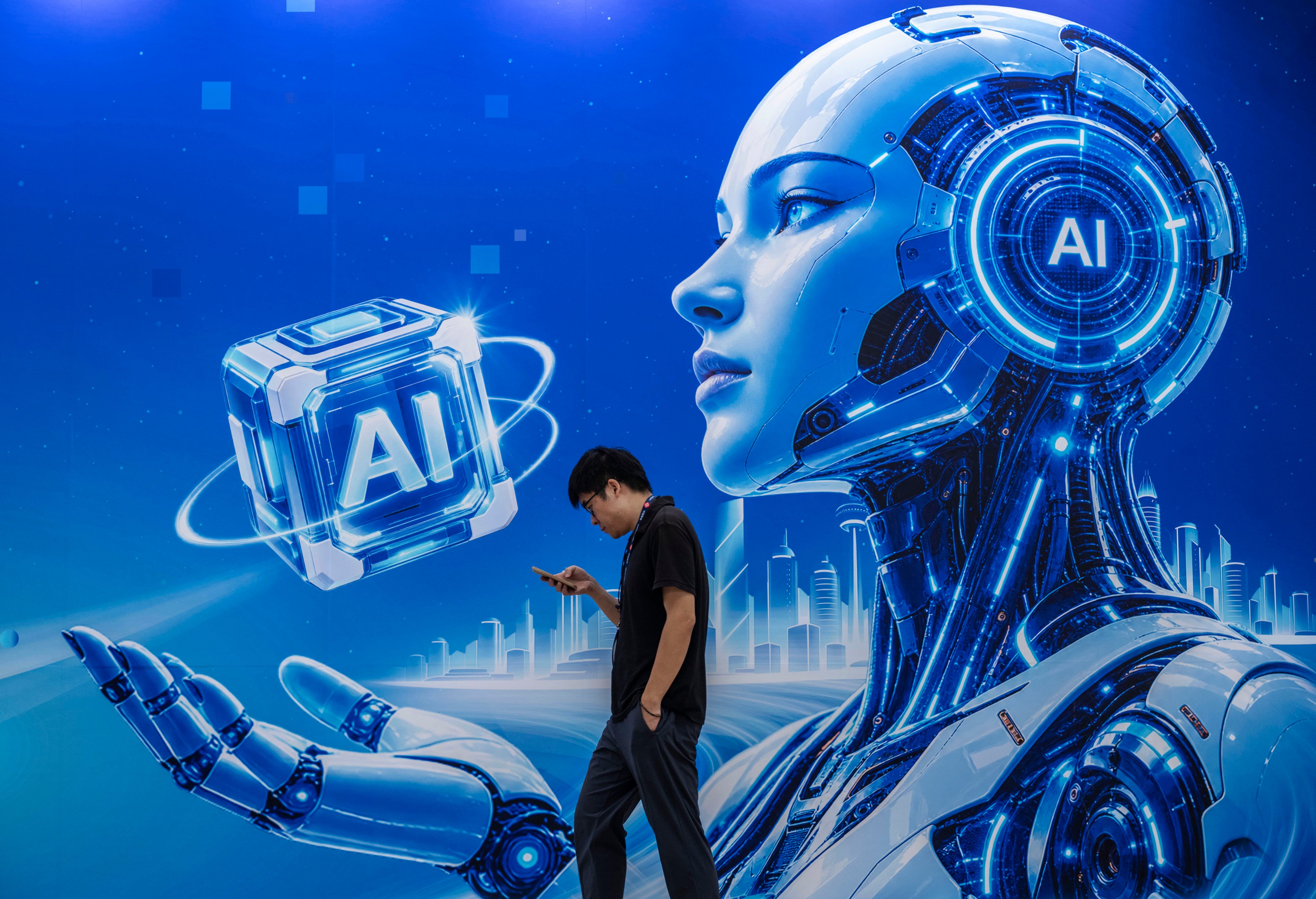 A visitor walks by a billboard for AI at the PT Expo, a major information and communications technology event, in Beijing last month. Photo: Getty Images