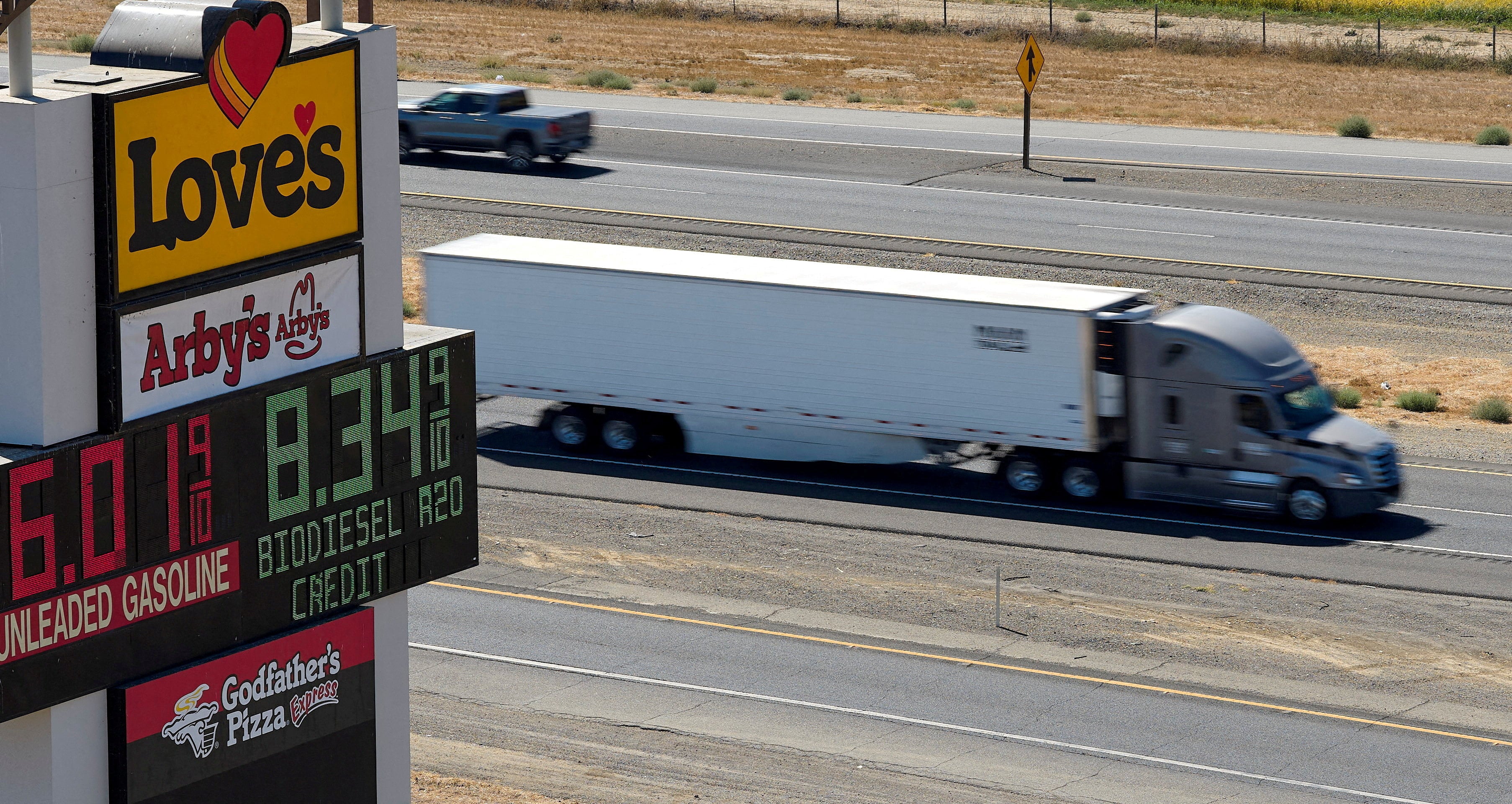 A truck drives past a sign advertising gas and diesel prices along Interstate 5 in Williams, California, the United States, on September 28. Photo: Reuters
