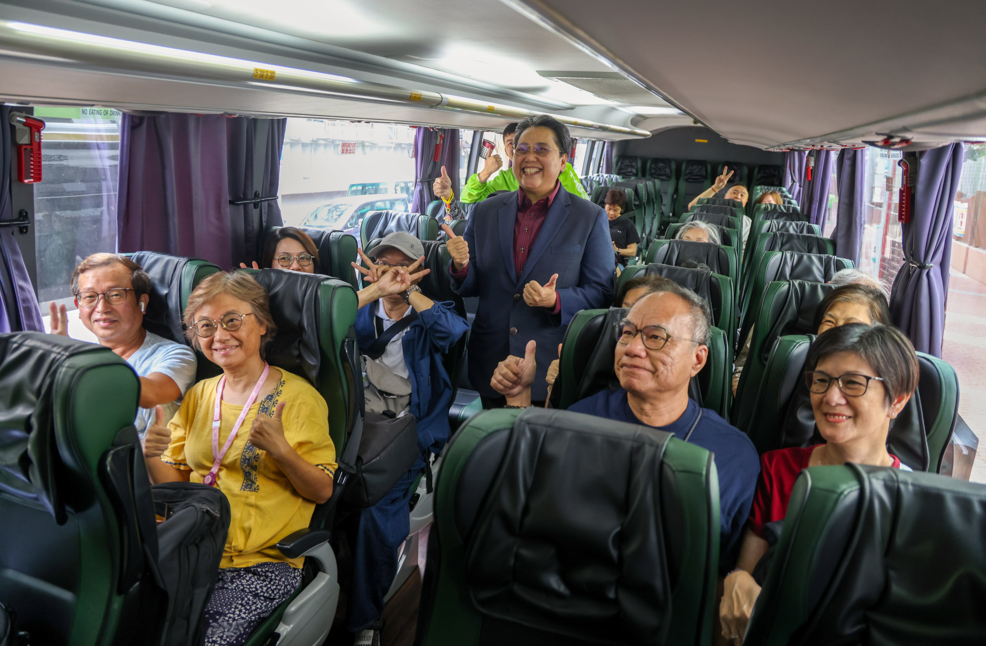 Tourists sit aboard a cross-boundary coach in Hong Kong bound for the newly opened Huanggang Port in Shenzhen on its official opening day. Photo: Silvia Siu