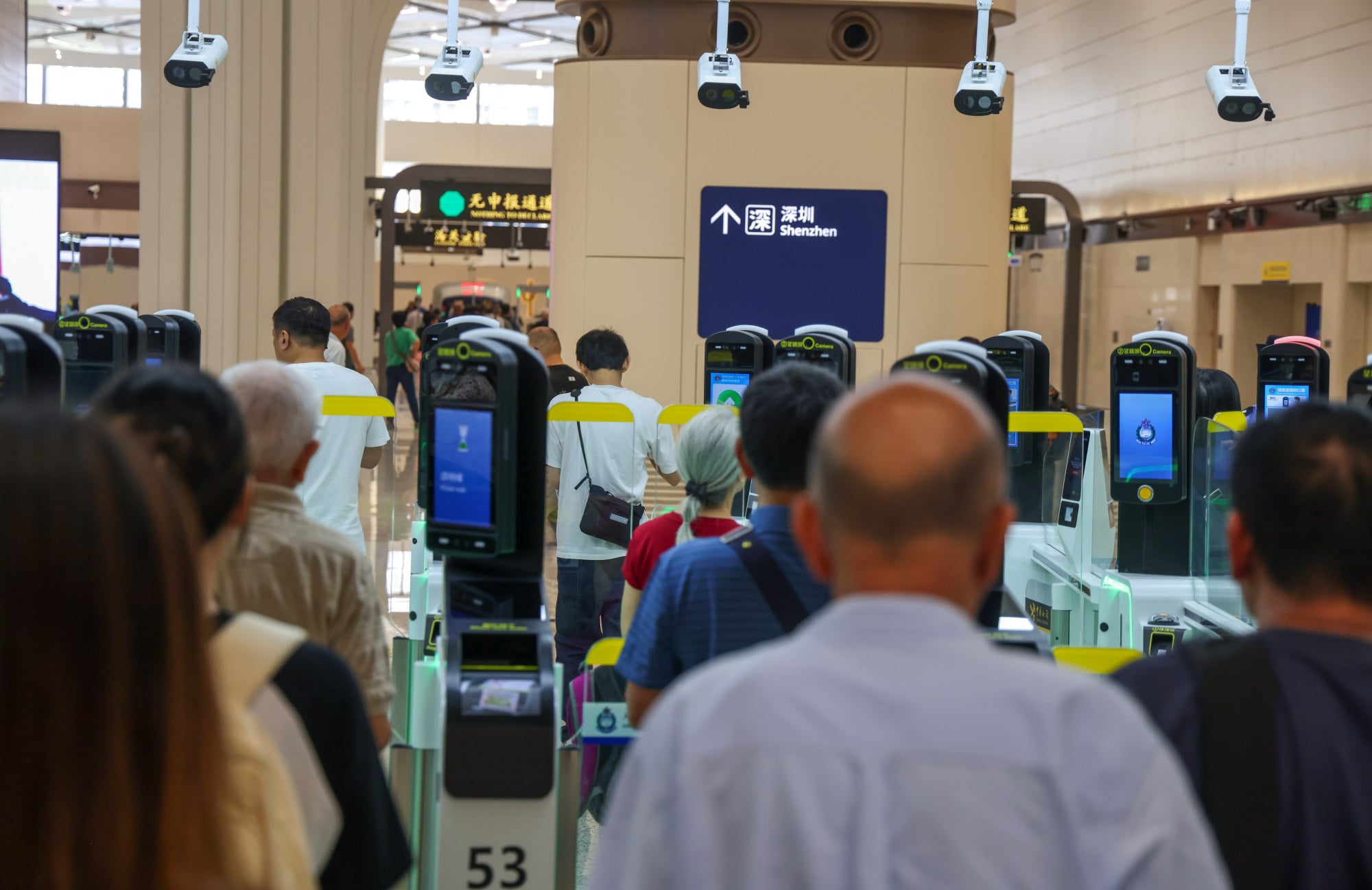 Travellers queue up to pass through the gates. Photo: Silvia Siu Travellers queue up to pass through the gates. Photo: Silvia Siu