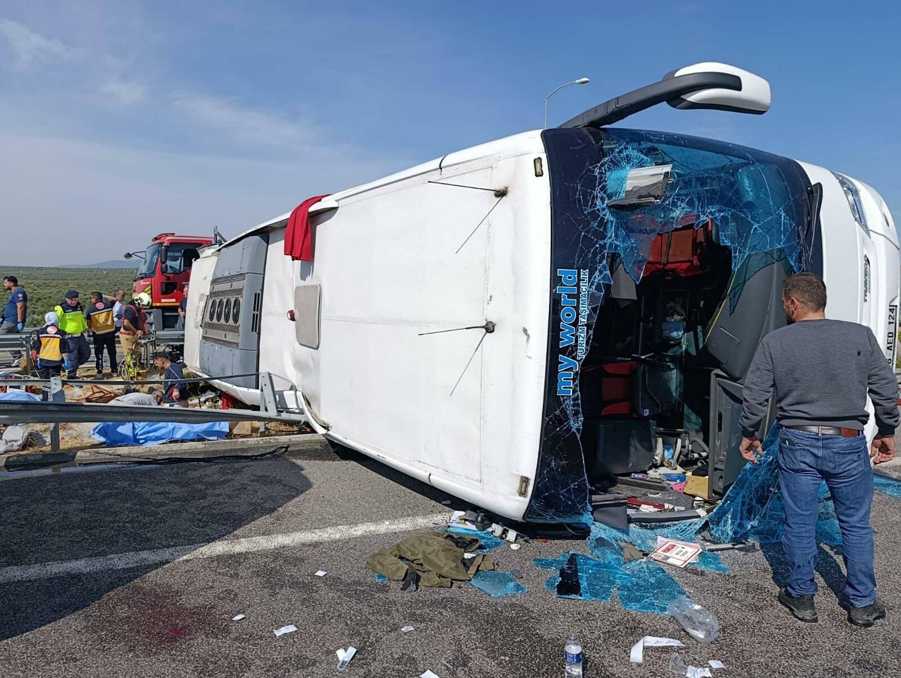Fire department and first aid officials at the site of a crash in Manisa, western Turkey on Sunday after a tour bus and a lorry collided. Photo: Handout / DHA (Demiroren News Agency) / AFP