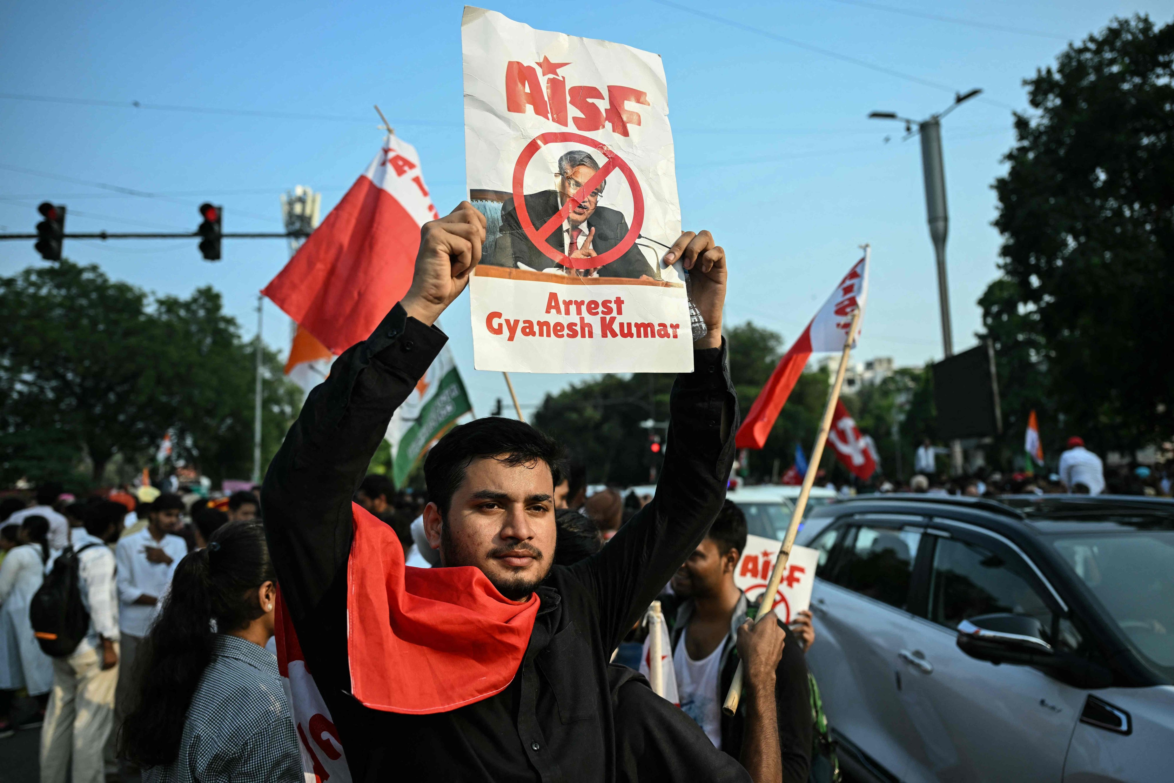 A demonstrator holds a placard demanding the resignation of India’s election chief in New Delhi, India, on Monday. Photo: AFP
