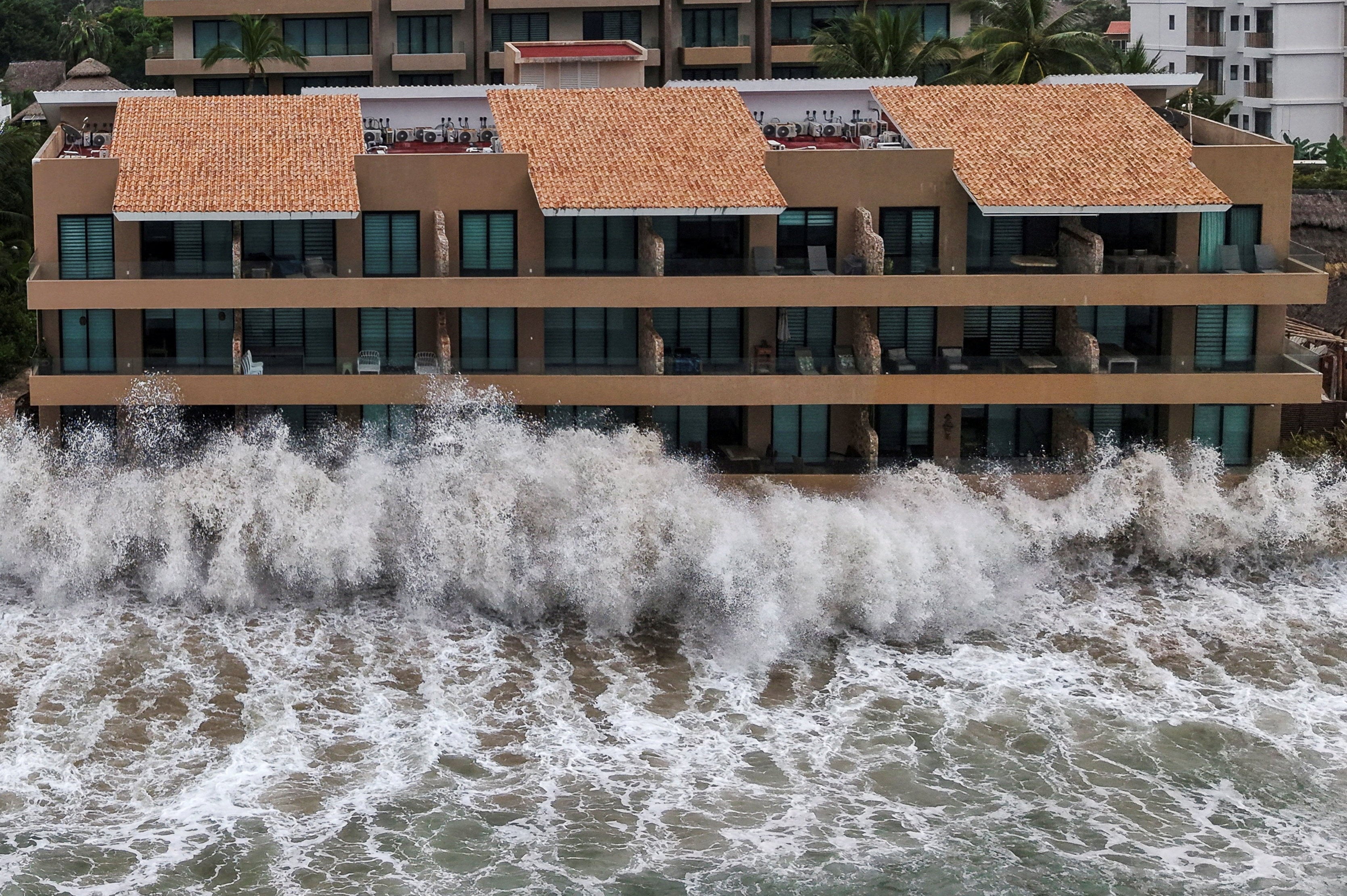 Waves from Hurricane Simon crash into buildings along Mexico’s Pacific coast in Nayarit state. Photo: Reuters