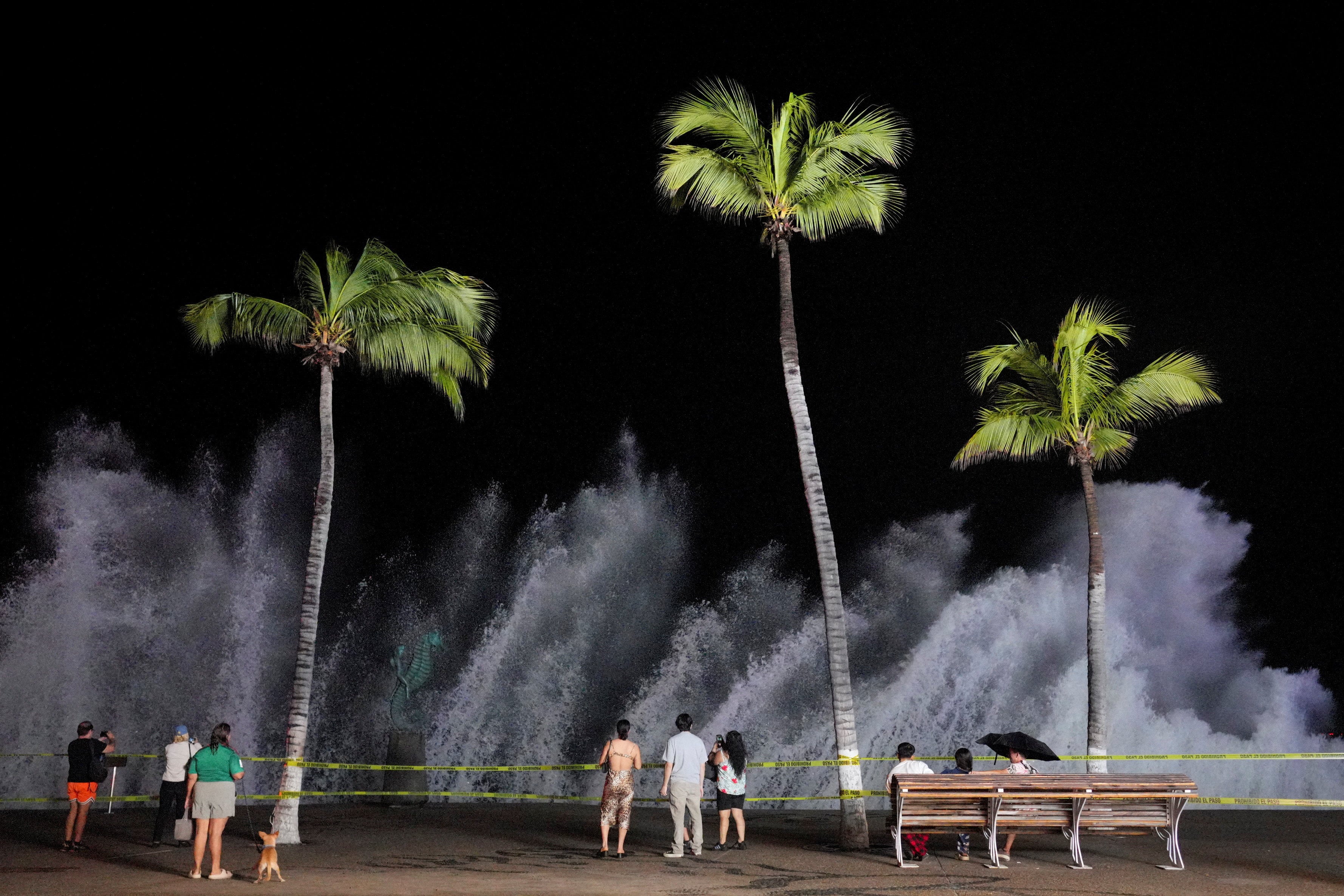 People watch waves crash against the waterfront promenade as Hurricane Simon approaches Mexico’s Pacific coast in Puerto Vallarta, Mexico on Sunday. Photo: Reuters