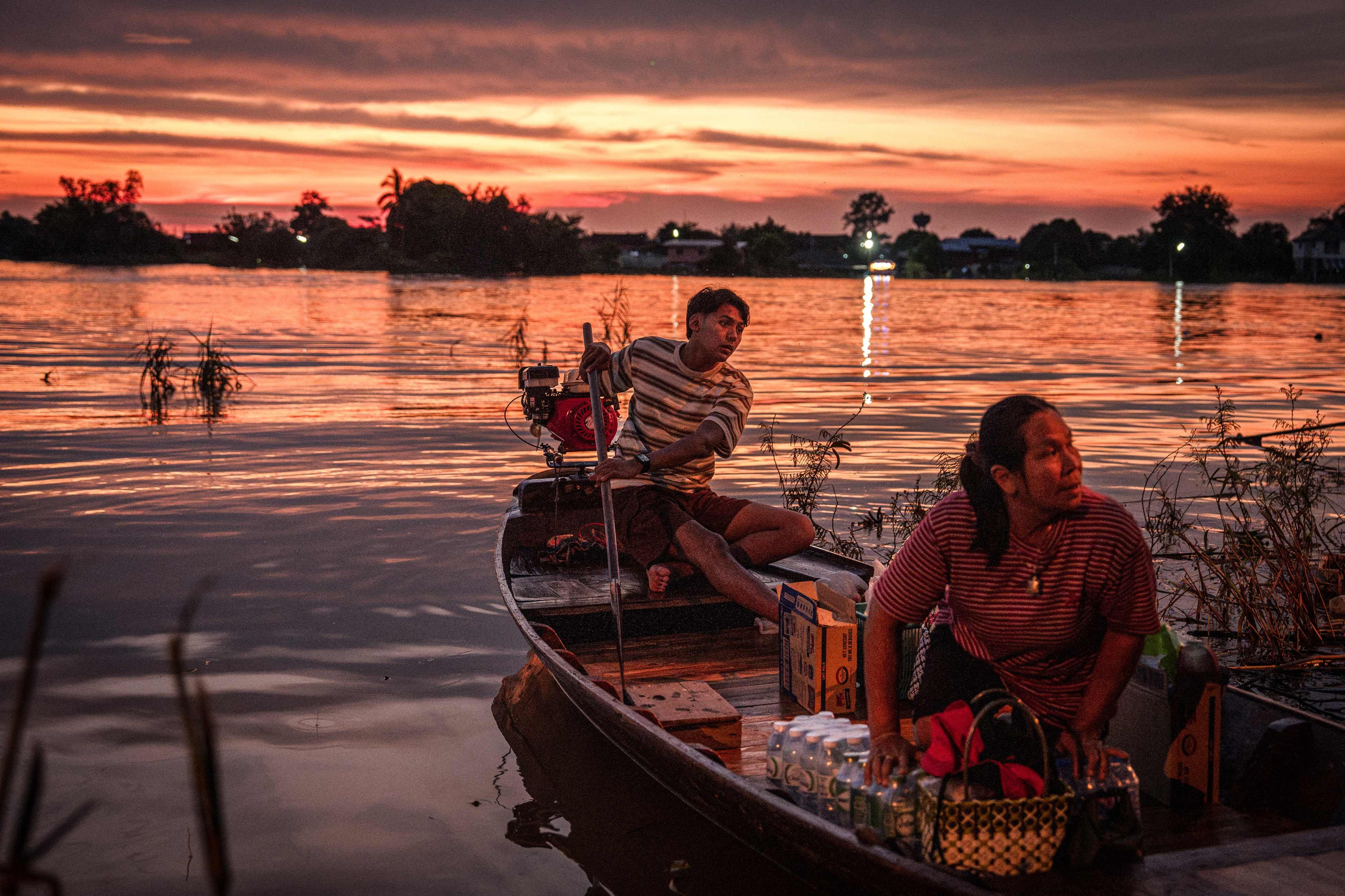 Villagers ride in a boat loaded with relief supplies in the flooded Bang Ban district of Ayutthaya province on October 6. Photo: AFP