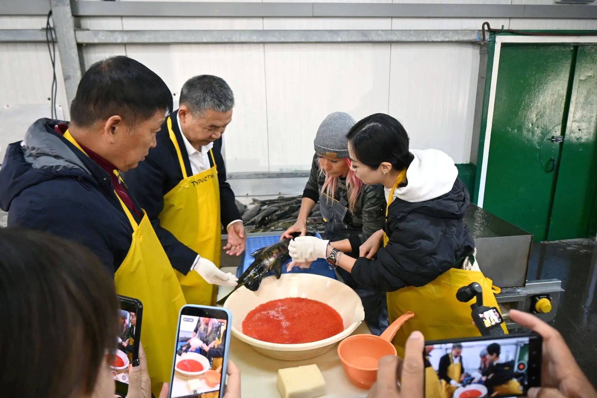 The Chinese delegation visits a seafood processing factory in the largest of the disputed islands. Photo: Kyodo