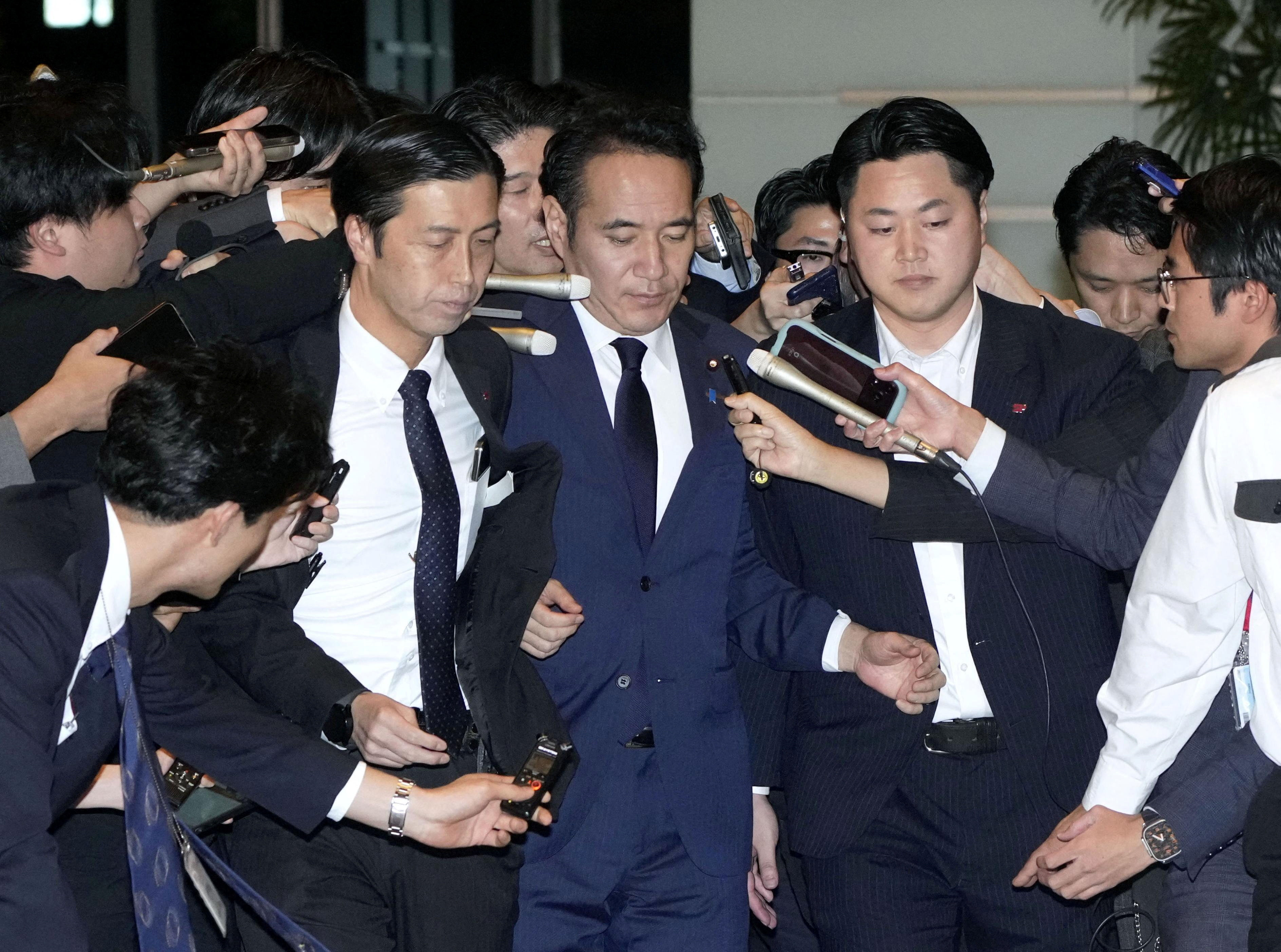 Agriculture Minister Kazuo Yana is surrounded by reporters as he arrives at the prime minister’s official residence to resign in Tokyo, on Wednesday. Photo: Kyodo via Reuters