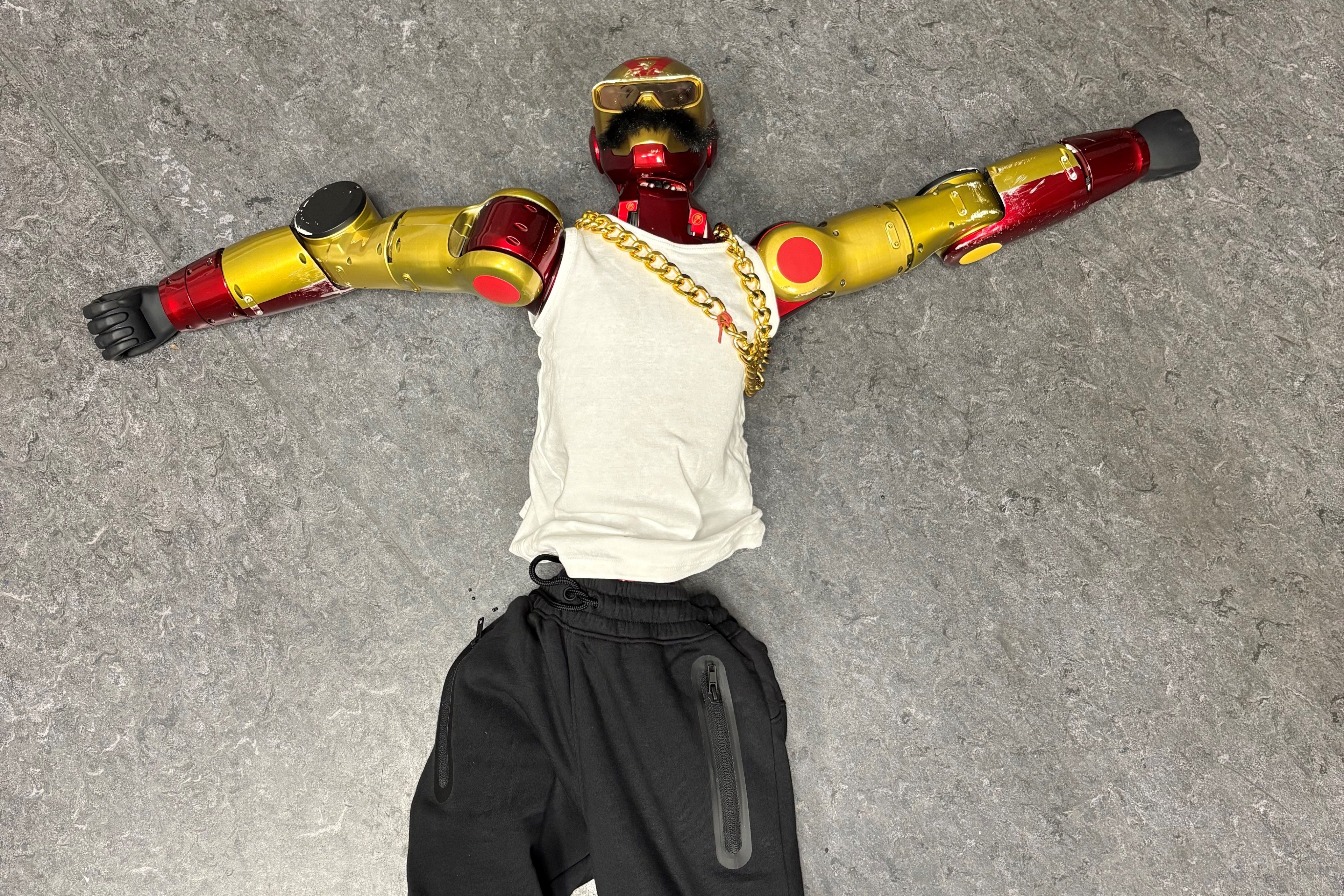 The robot was dressed in a white tank top, black sweatpants, sunglasses, a gold chain and a fake mustache. Photo: Cologne Police via AP