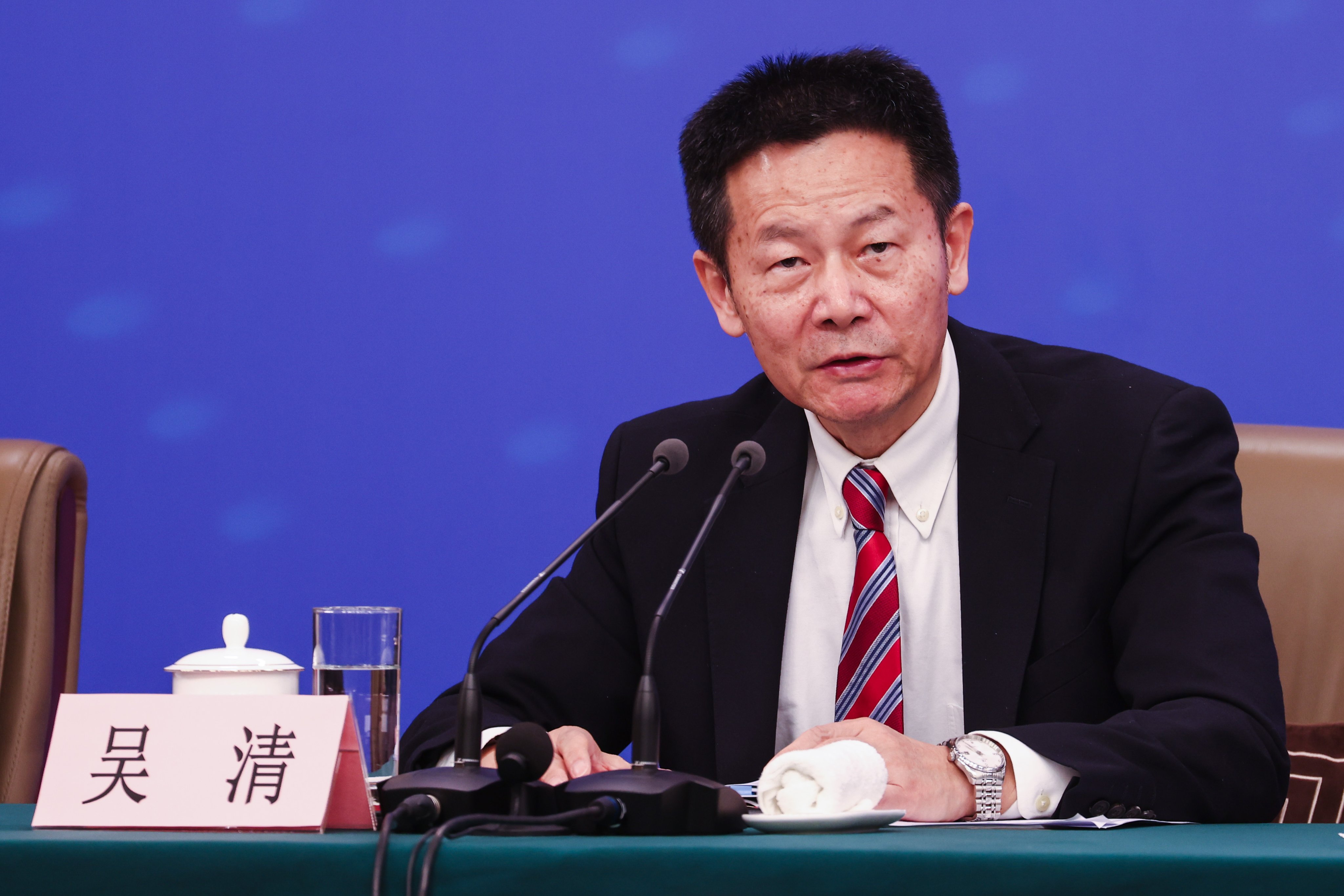 Wu Qing, chairman of the China Securities Regulatory Commission, speaks during a press conference in Beijing on March 6, 2026. Photo: EPA