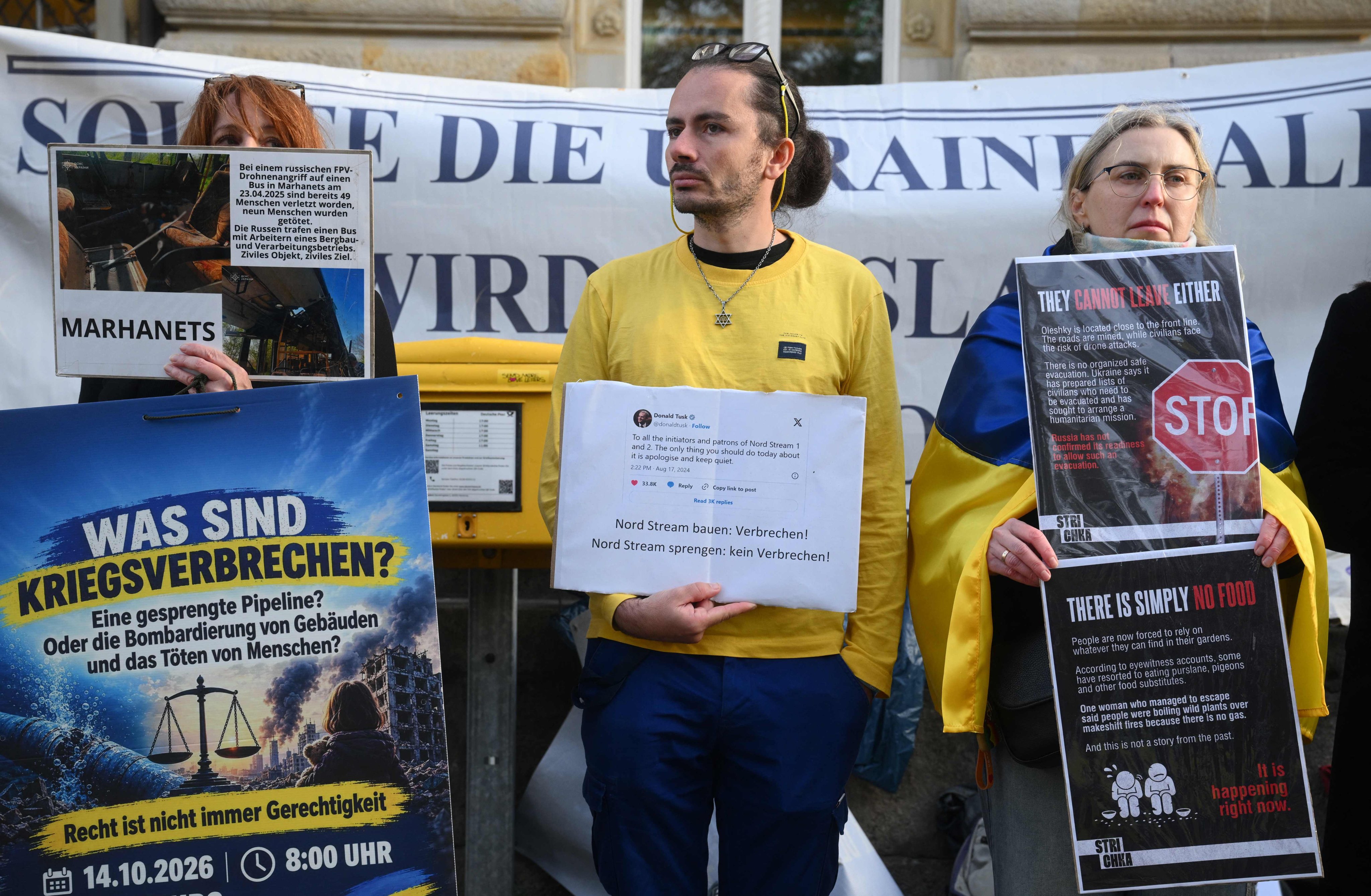 Pro-Ukraine protesters gather outside a courthouse ahead of a trial over the Nord Stream pipeline bombings, in Hamburg, Germany, on Wednesday. Photo: AFP