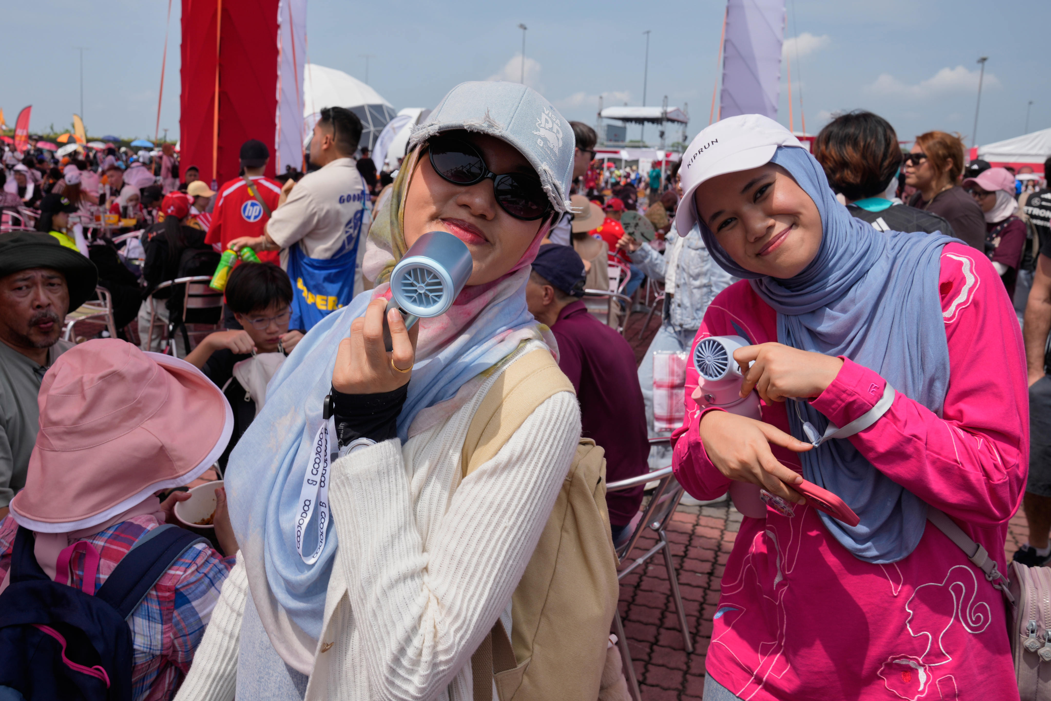 Young attendees arrive at the Sepang International Circuit in Malaysia on October 2 to watch a practice run ahead of the relocated Bahrain Grand Prix. Photo: AP