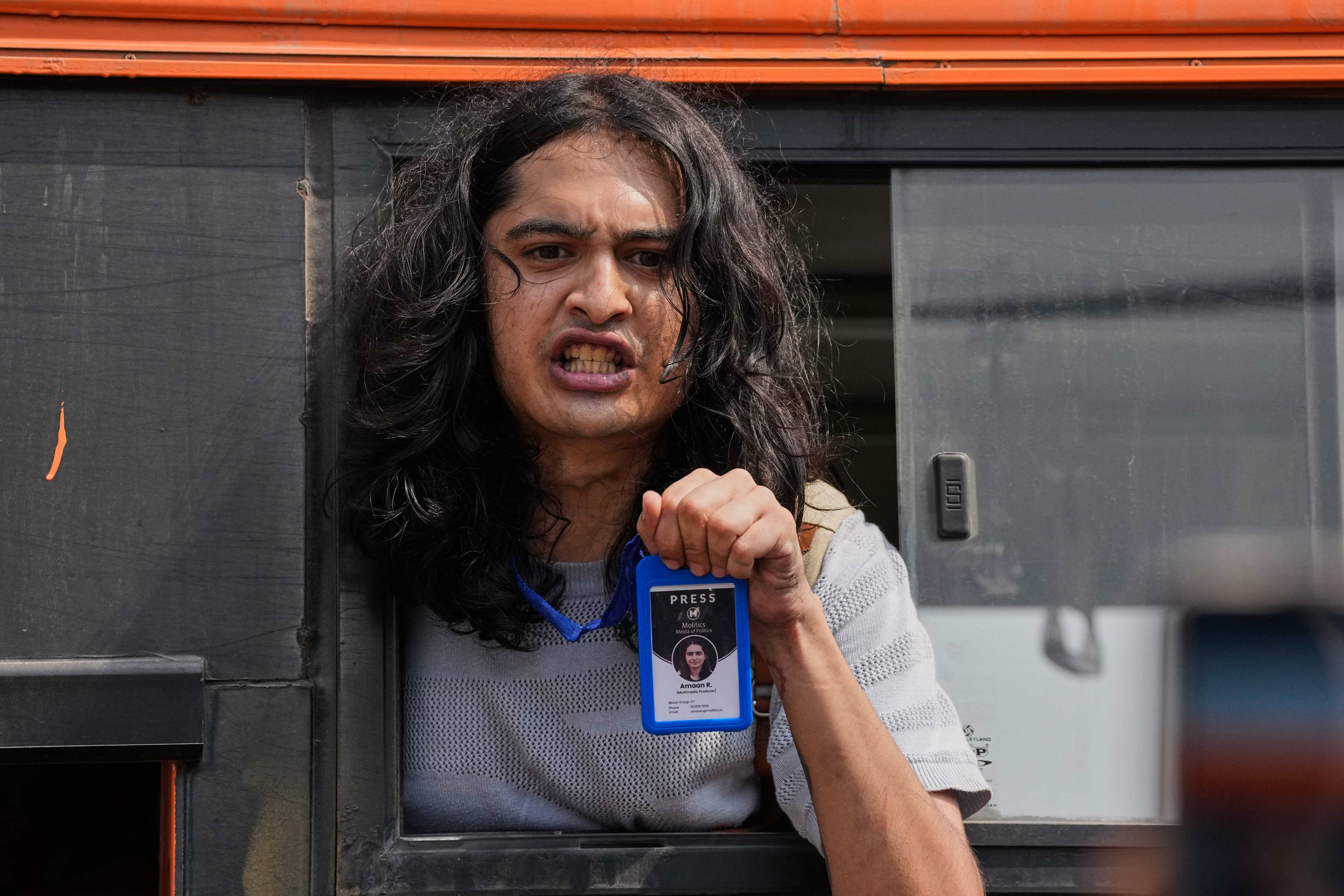 Detained journalist R. Amaan shows his press card inside a police vehicle during a protest in New Delhi, India, on Saturday. Photo: AP