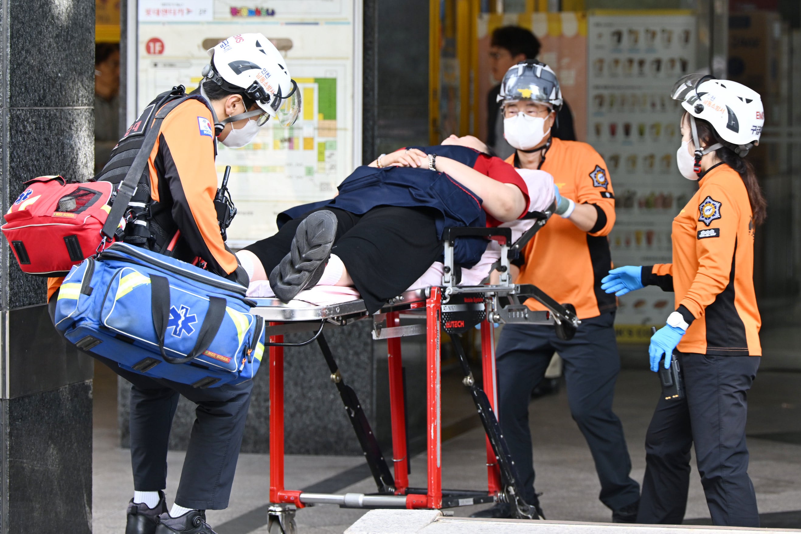 Members of a rescue team carry an injured person outside a shopping centre in Incheon, South Korea, following a stabbing rampage on Tuesday. Photo: Yonhap via AP