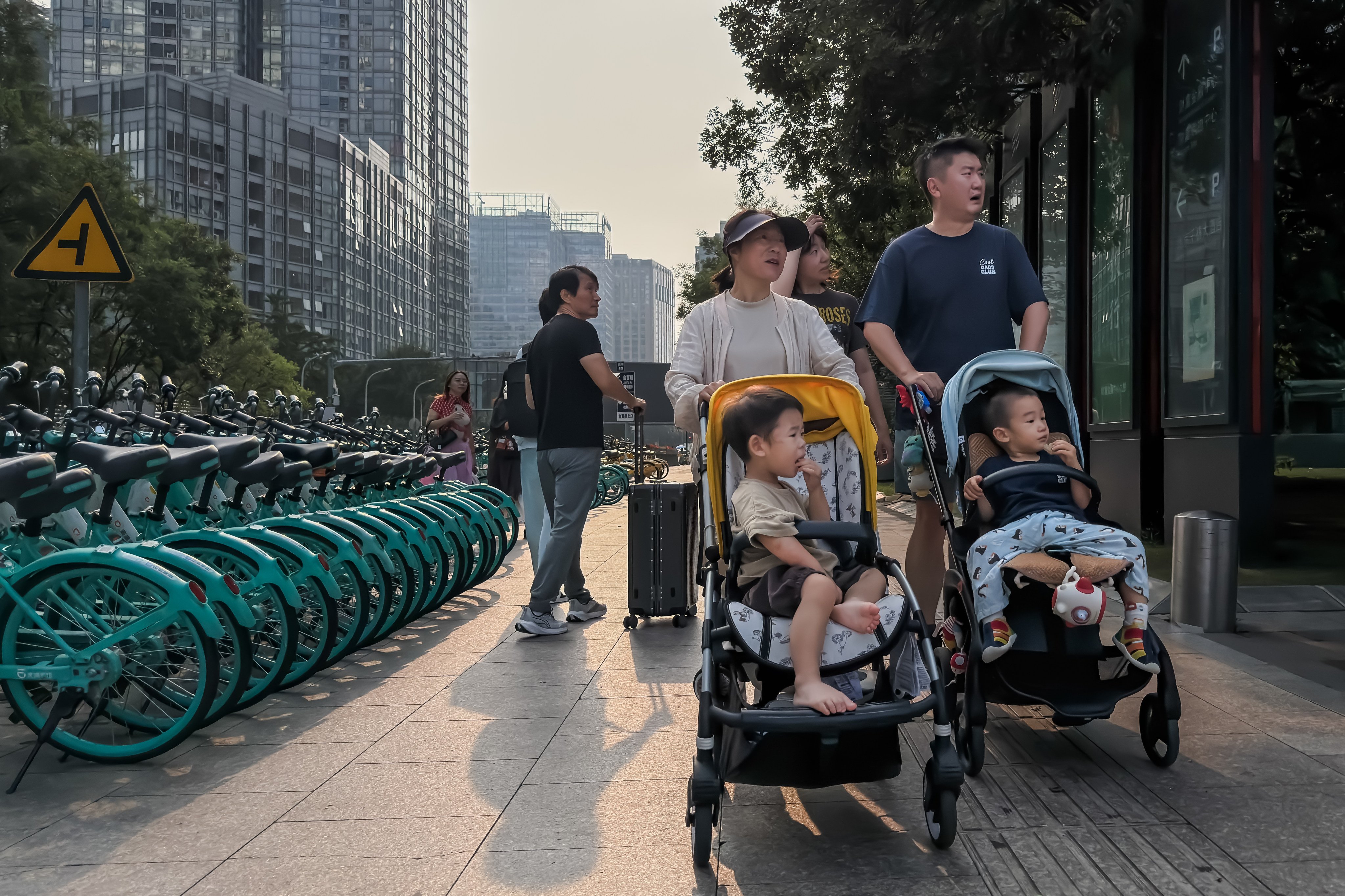 Adults push children in strollers in Beijing. Photo: Getty Images