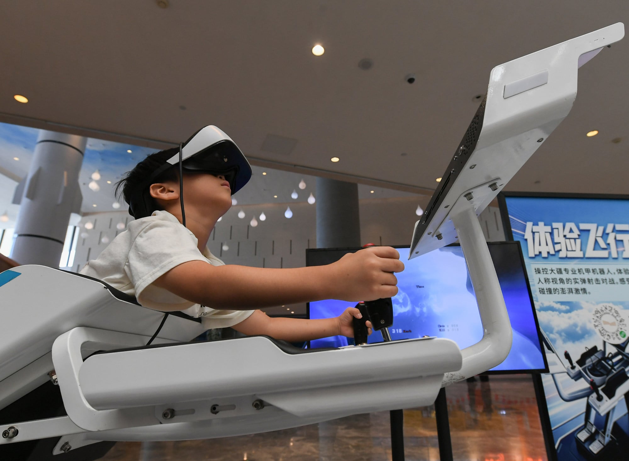A child tries a simulated flight using a pair of virtual reality glasses at a science and technology museum in Jinhua, China on October 6. Photo: Xinhua A child tries a simulated flight using a pair of virtual reality glasses at a science and technology museum in Jinhua, China on October 6. Photo: Xinhua