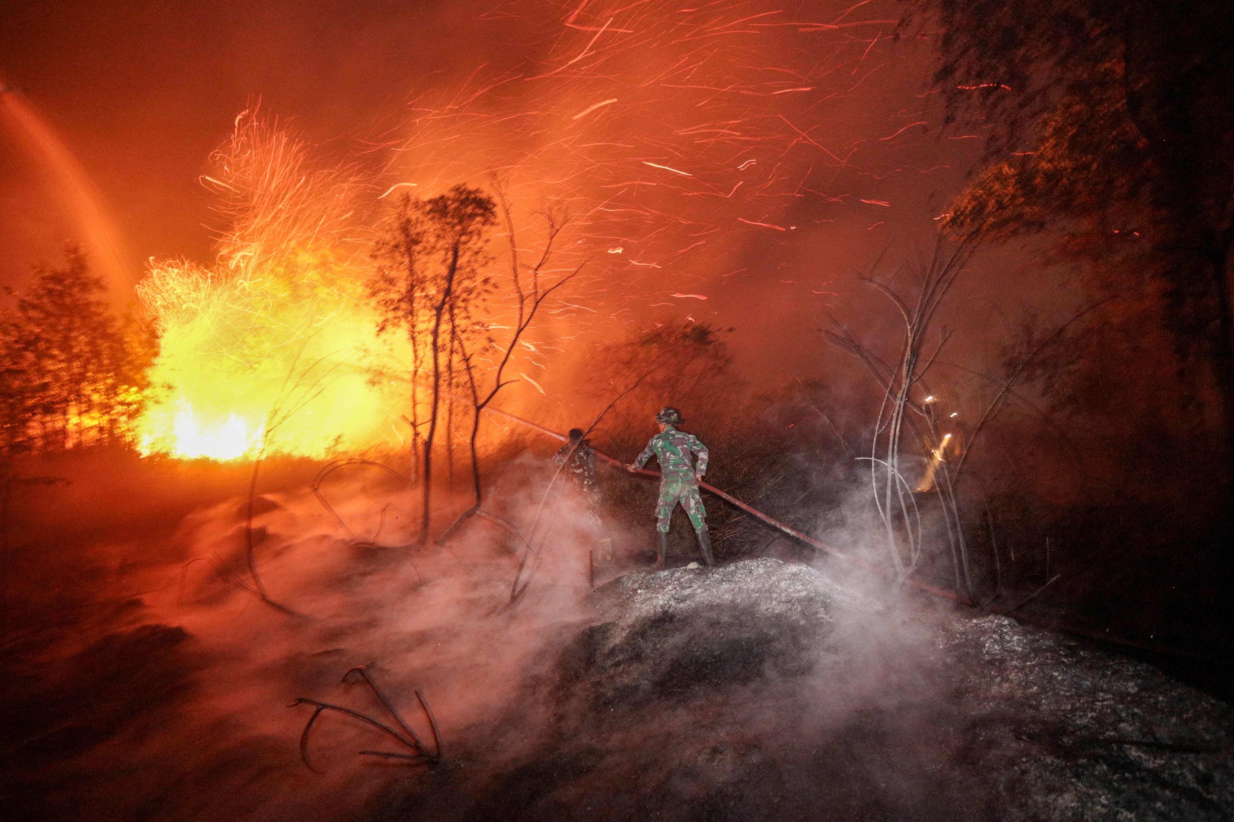Soldiers and firefighters work on cointaining a wildfire in Banjarbaru, Indonesia’s South Kalimantan province, on Tuesday. Photo: AFP
