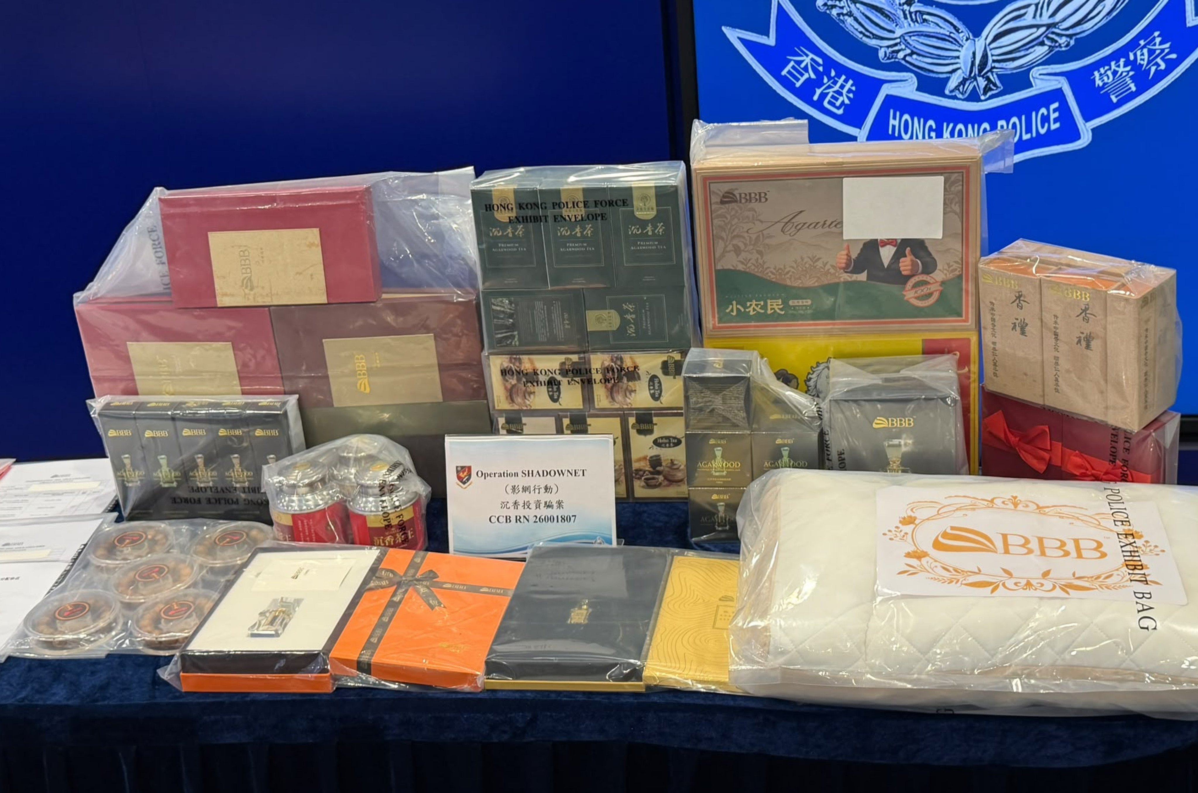 Police display seized evidence. Officers searched BBB Group's premises in Kwun Tong, seizing about HK$540,000 in cash, 25 laptops and mobile phones, investment contracts and various types of suspected agarwood goods. Photo: handout