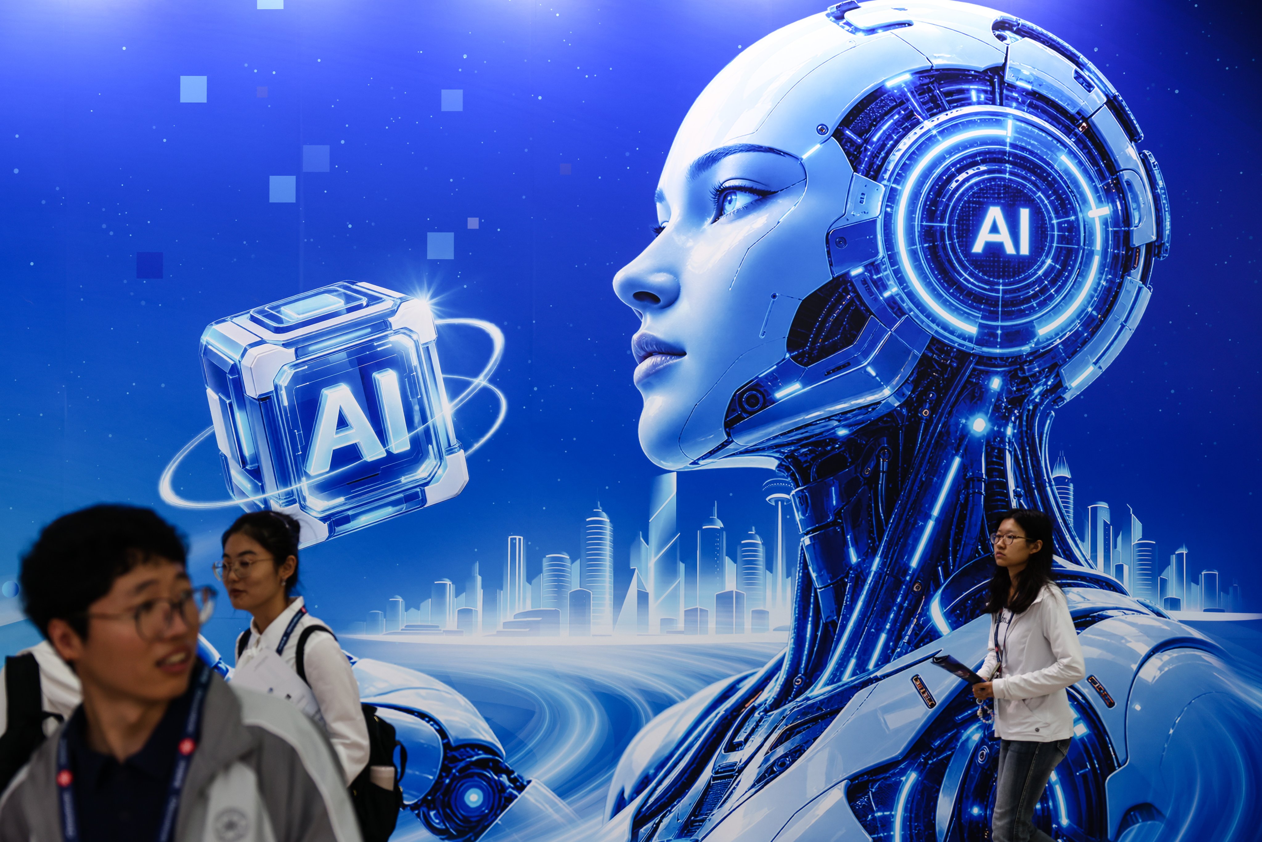 Attendees walk past an AI-themed backdrop at the People and Technology Expo in Beijing, China, on September 22. Photo: EPA