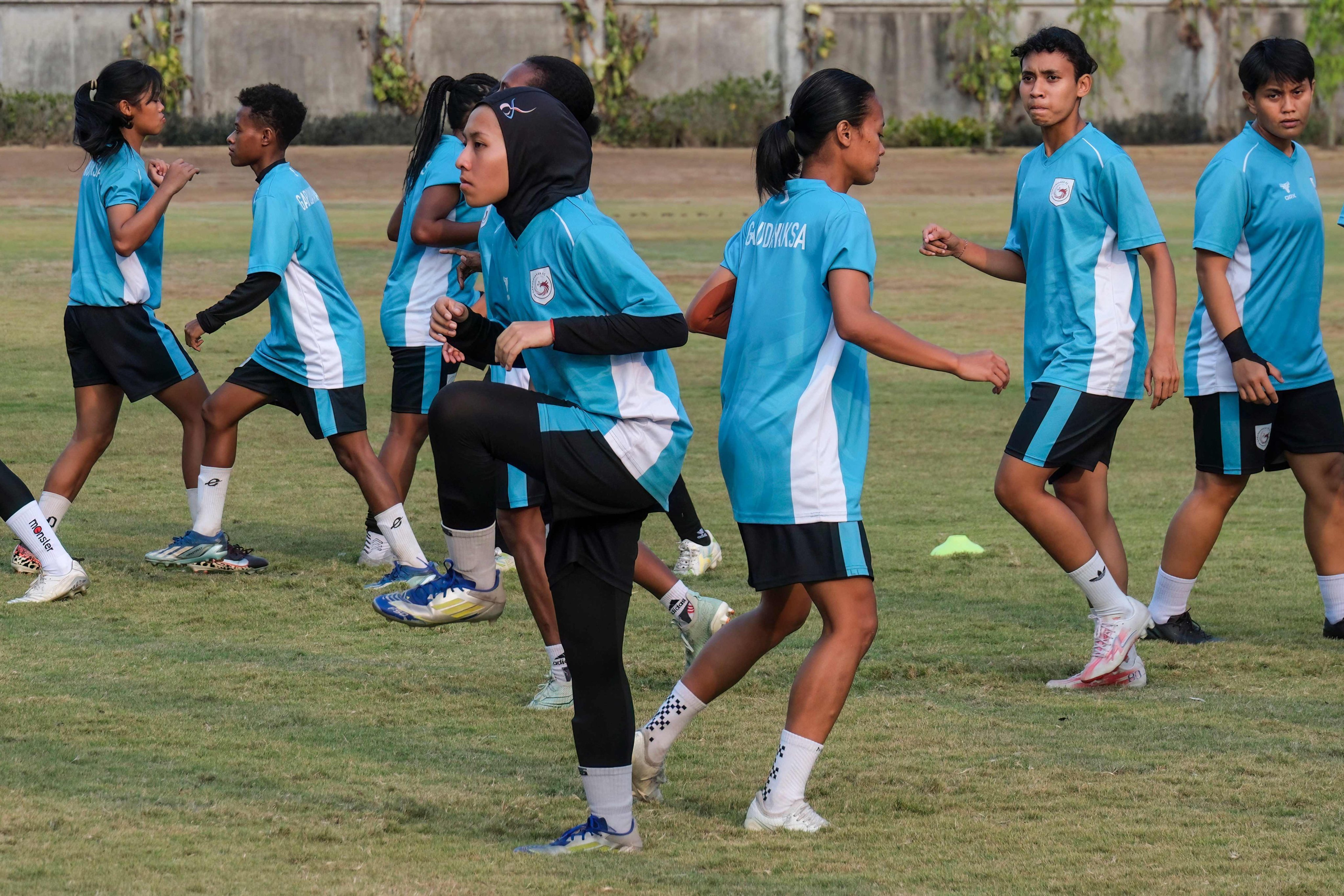 Garudayaksa FC’s Zahra Naqiyyah (centre, wearing hijab) and her teammates performing drills during a training session in Bekasi, West Java province. Photo: AFP