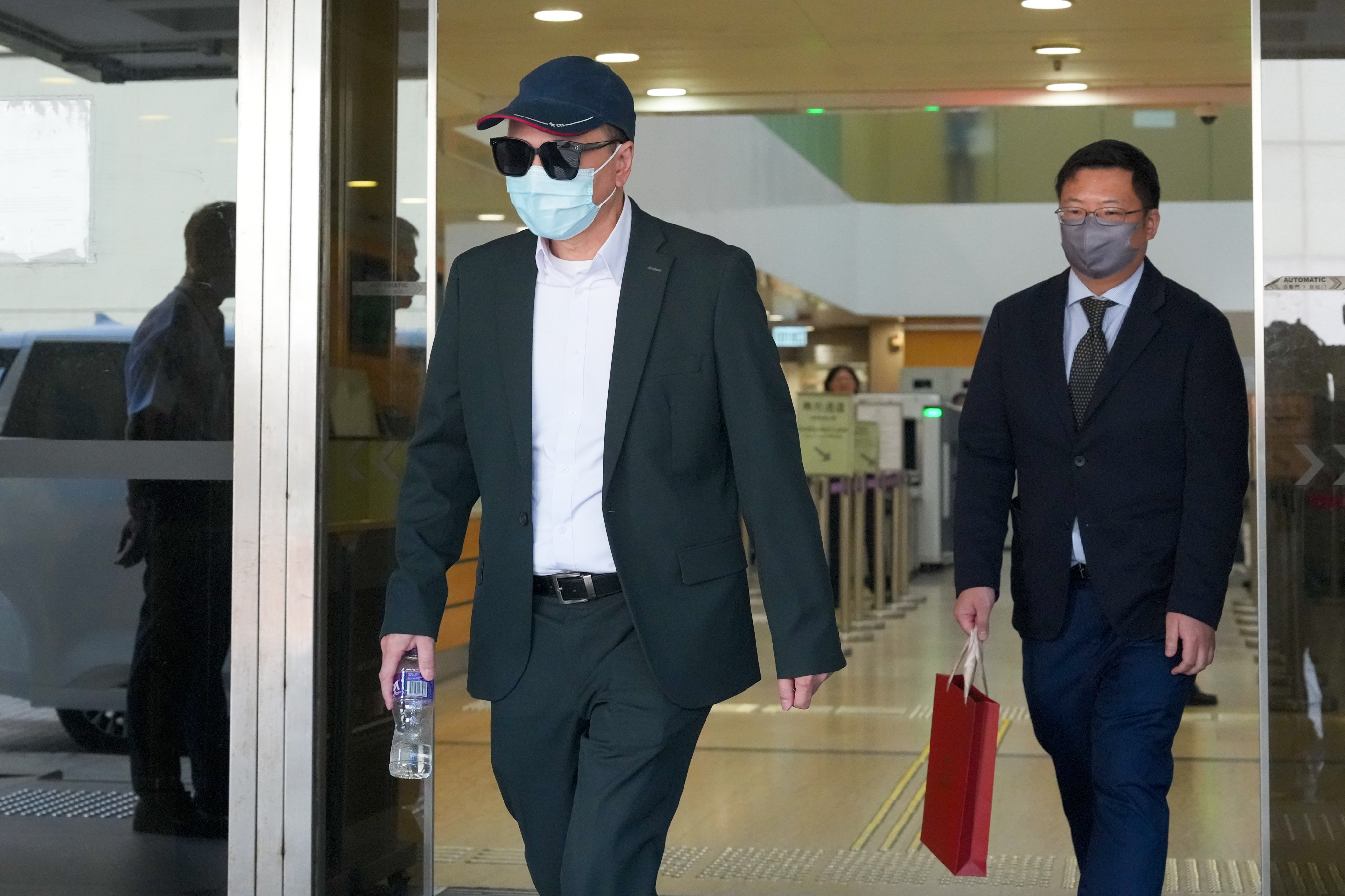 Tam Chak-kwan (left) leaves the High Court after giving evidence. Photo: Dickson Lee