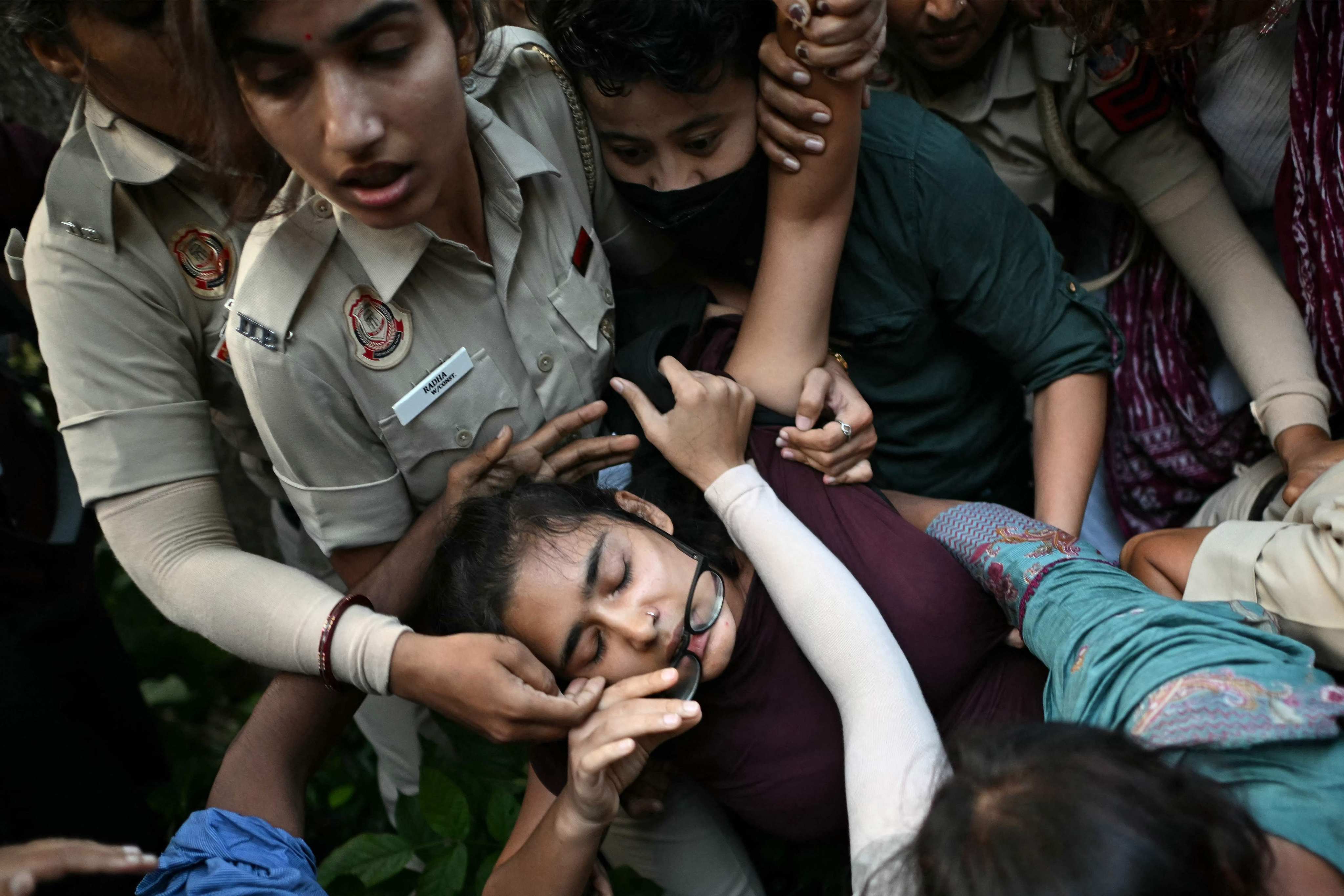 Security forces detain All India Students’ Association President Neha Bora (centre) during a protest in New Delhi, on Friday. Photo: AFP