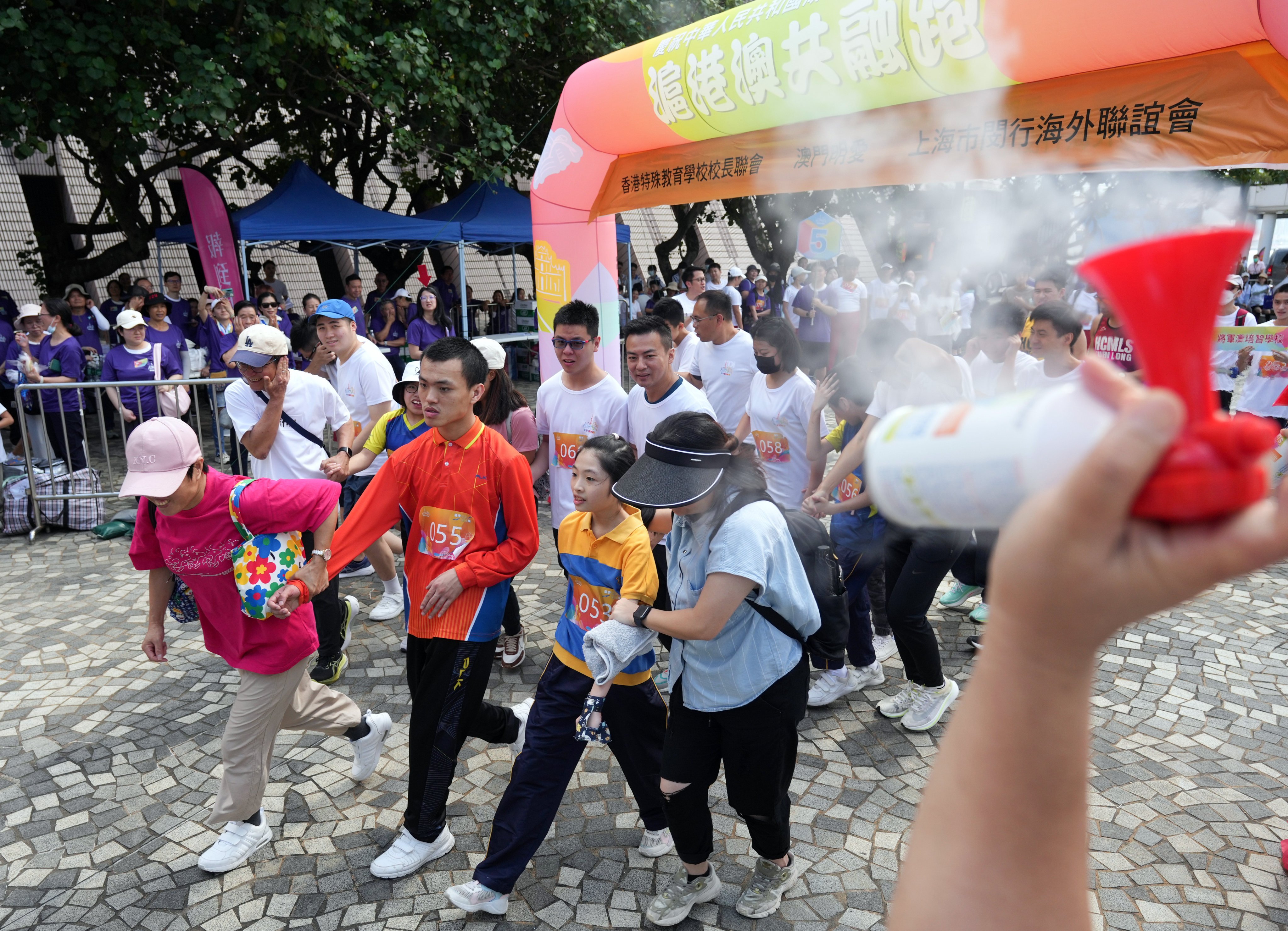 Participants pass Tsim Sha Tsui in 2024 during an inclusive run for youth with special educational needs. Photo: Eugene Lee
