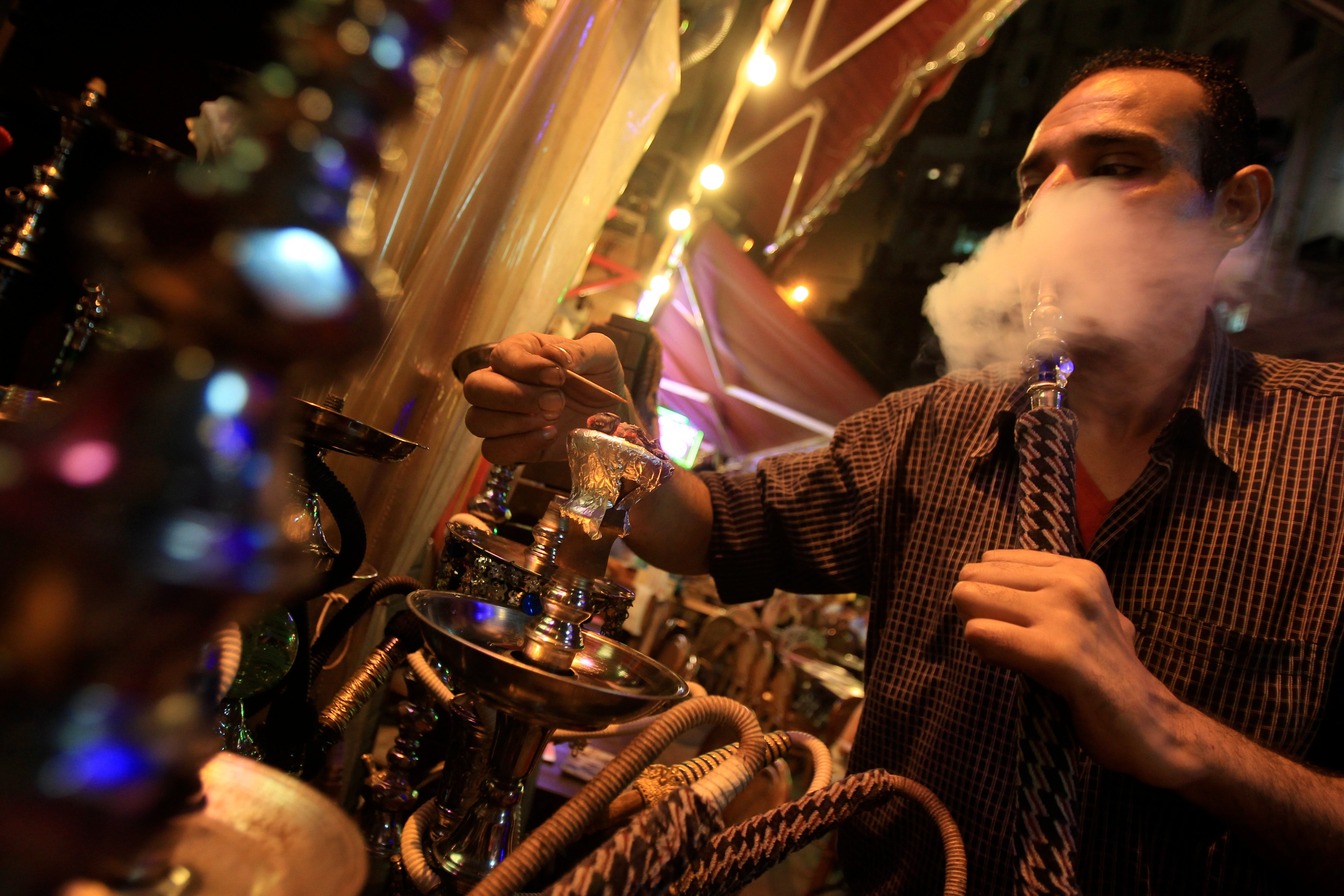 A worker prepares a water pipe at a shisha bar in Lan Kwai Fong, Central. Photo: SCMP