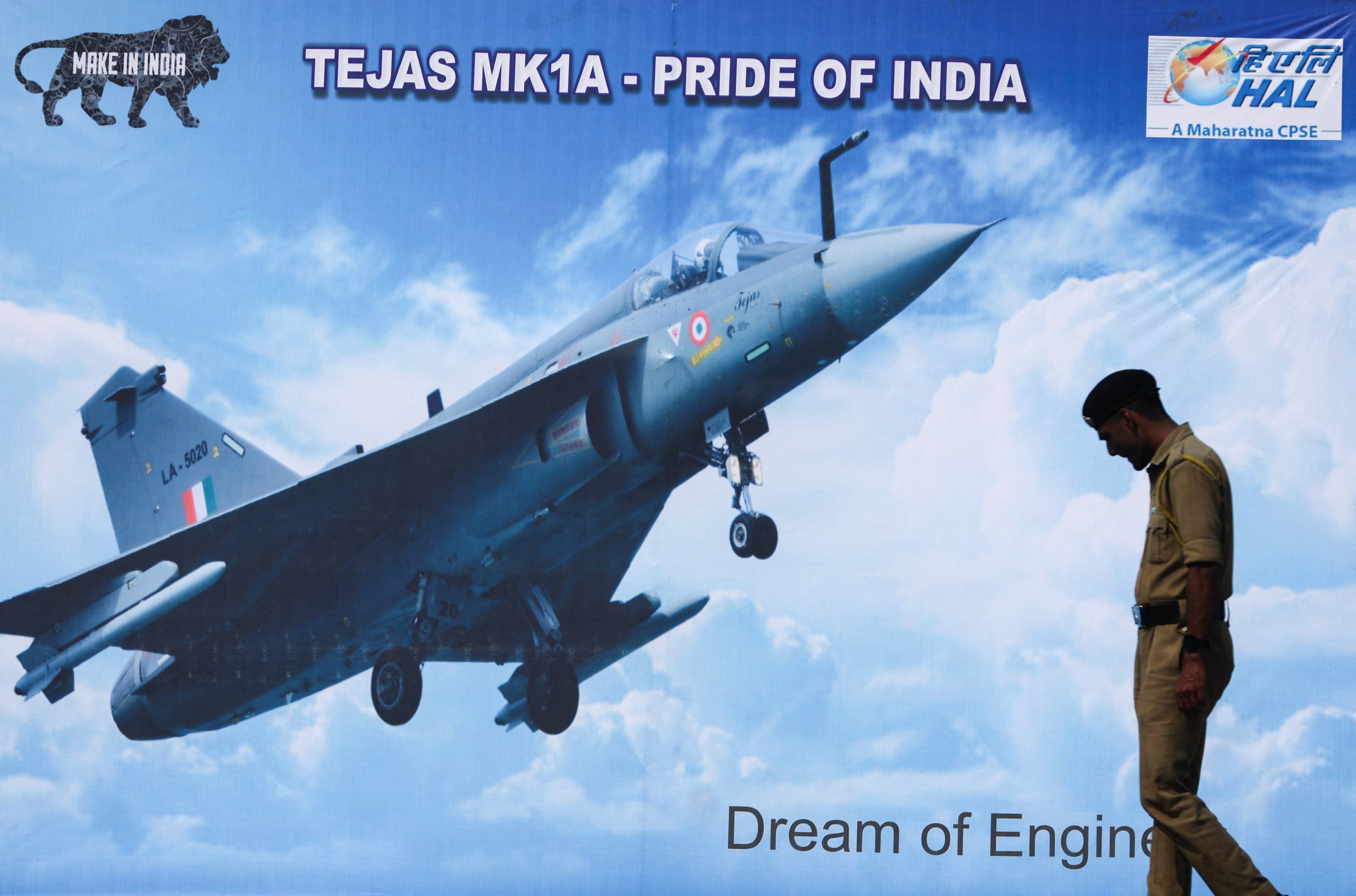 A policeman walks past a poster of a Hindustan Aeronautics Limited Tejas Mark 1A ahead of its maiden flight in India last October. Photo: Reuters