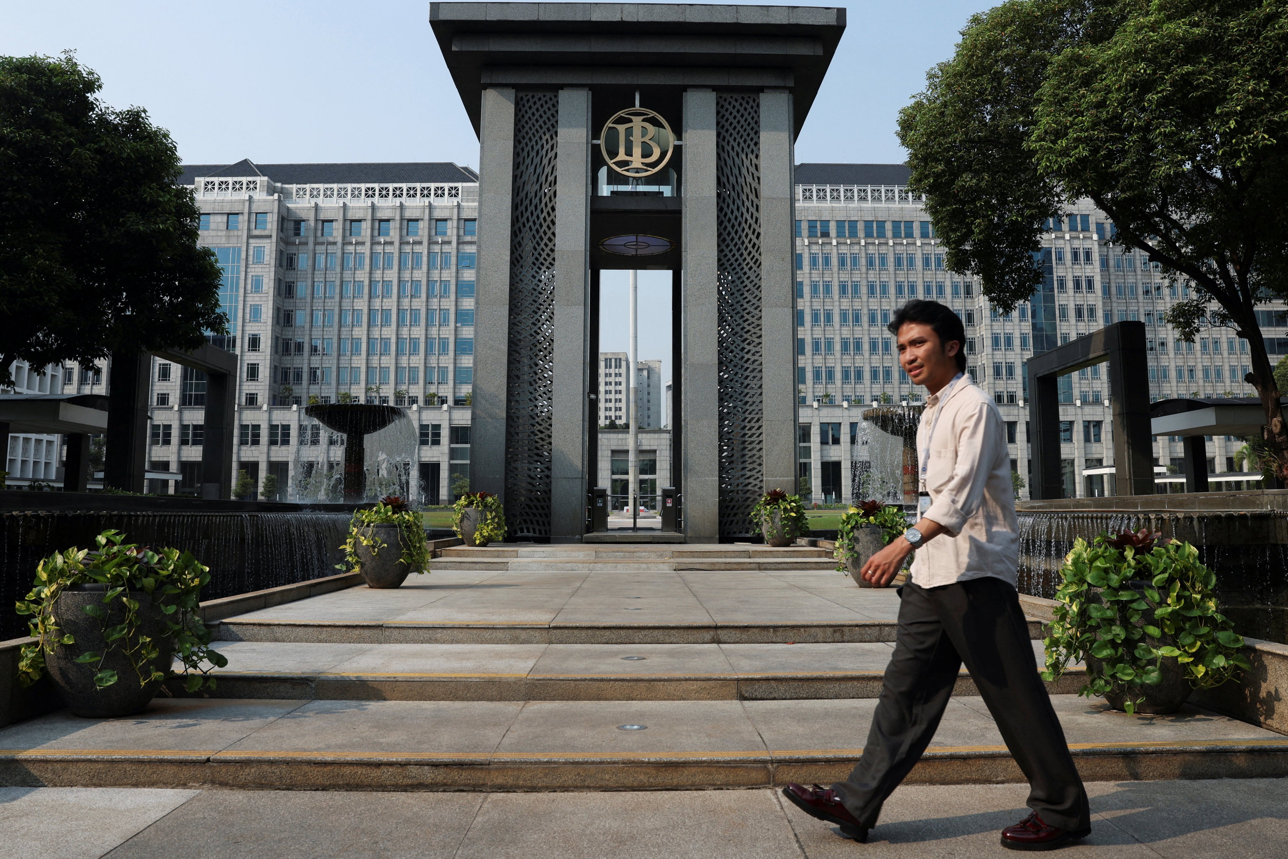A worker walks past the headquarters of Bank Indonesia, Indonesia’s central bank, in Jakarta on Monday. Photo: Reuters
