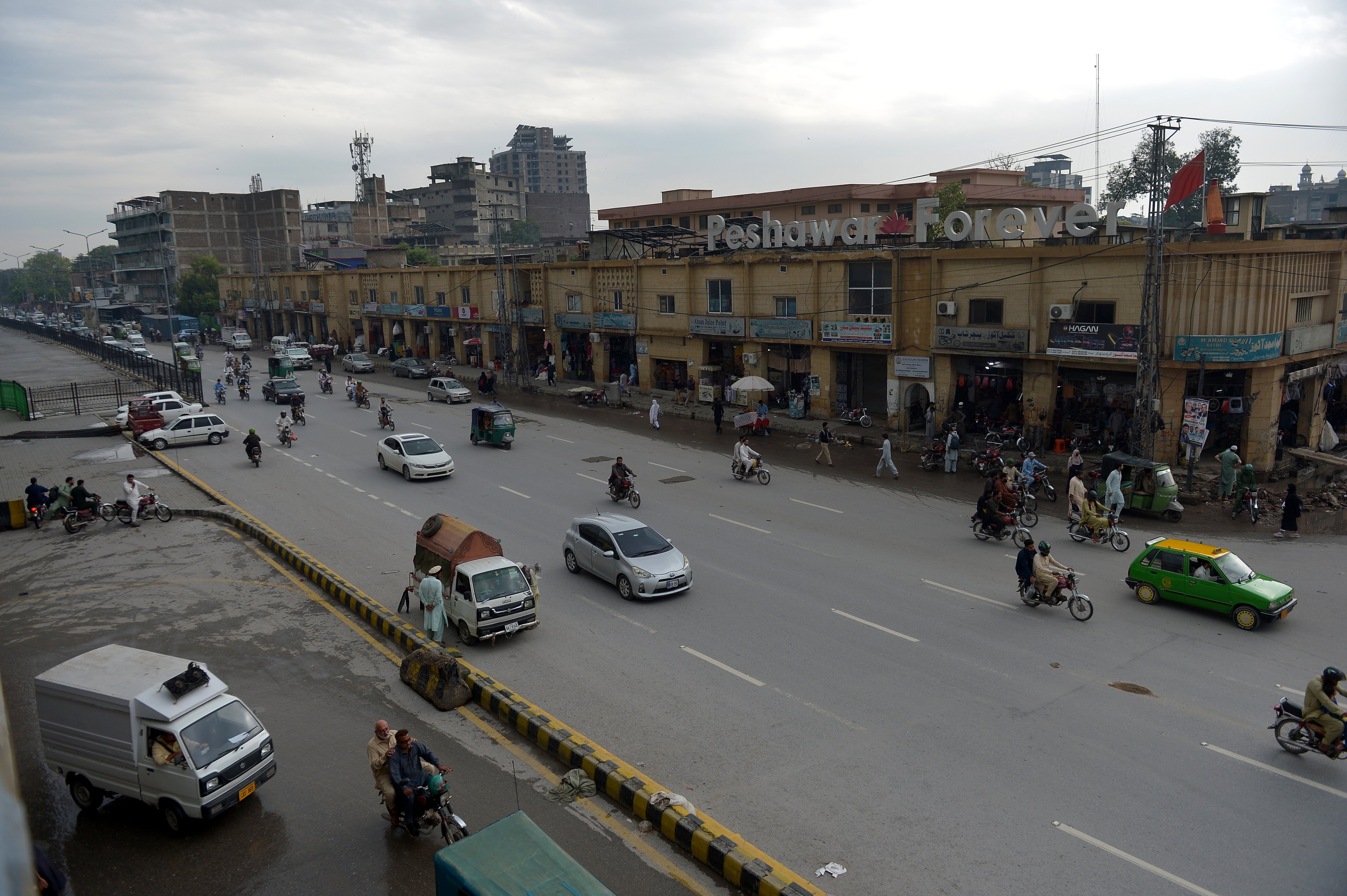 Traffic resumes on reopened roads following the removal of security barricades and shipping containers in Peshawar, Pakistan, on Tuesday. Photo: EPA