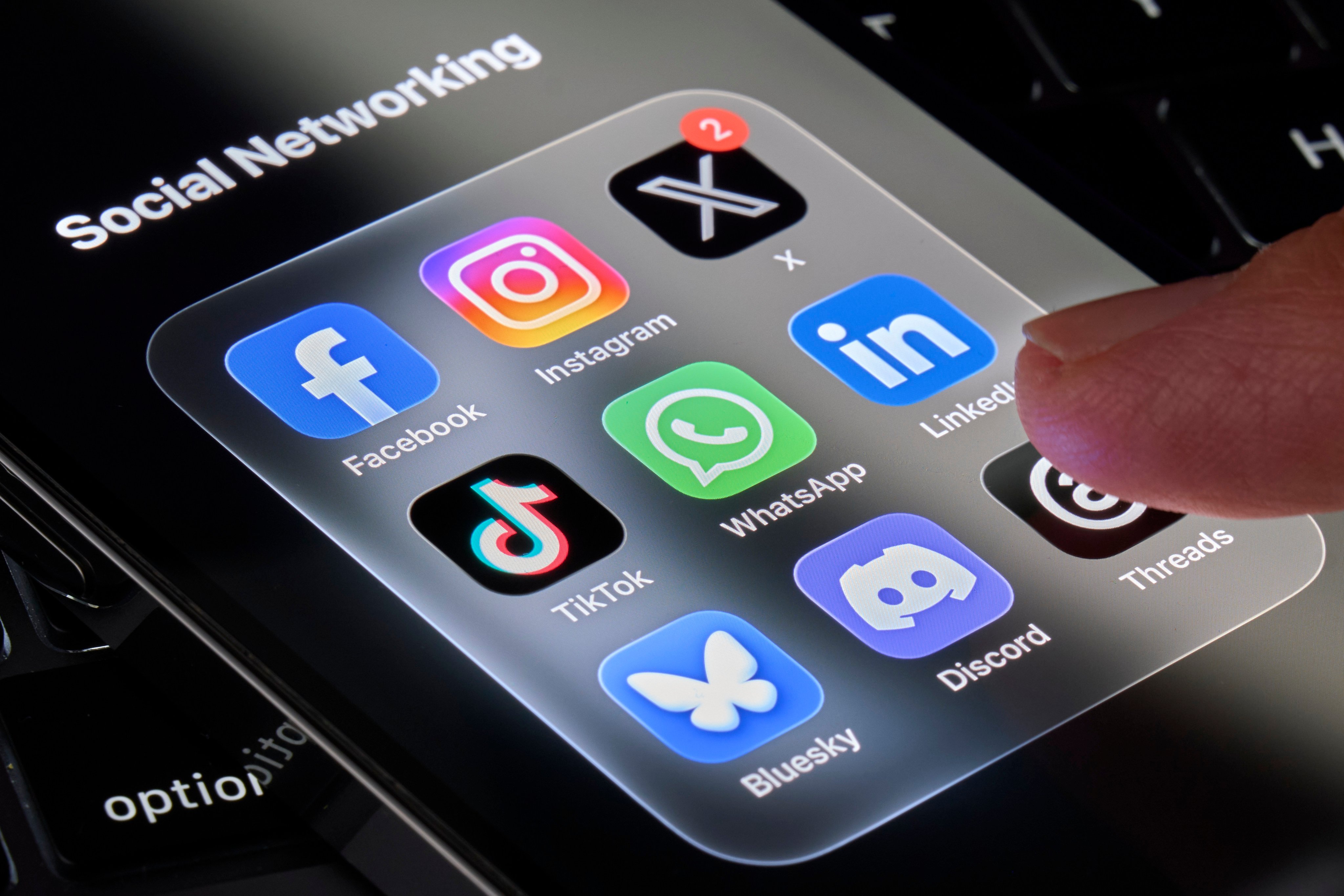 A smartphone screen displaying icons of several social media platforms. Photo: NurPhoto/Getty Images
