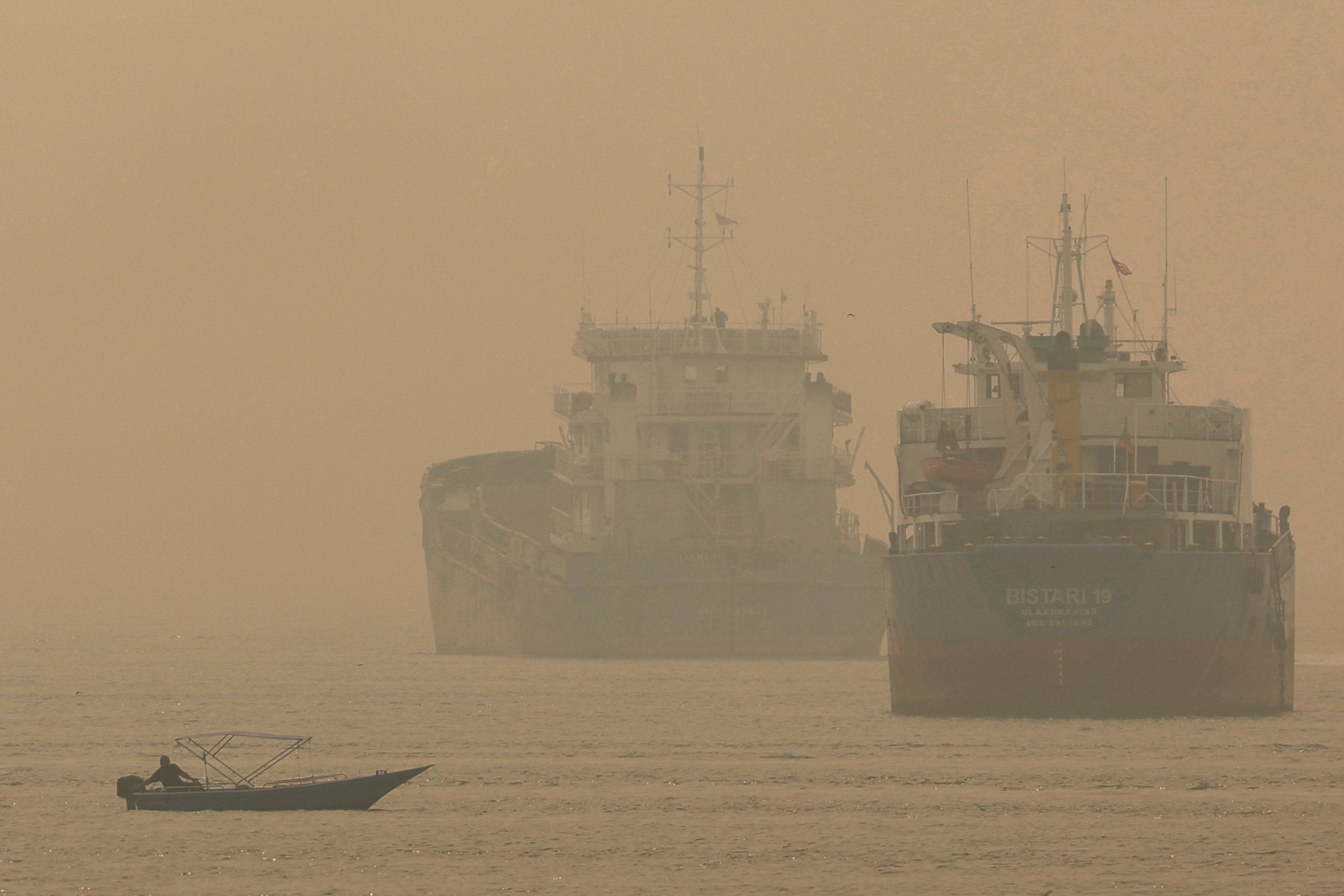 Ships off Klang, Malaysia, are shrouded in haze from wildfires in Indonesia on Thursday. Photo: Reuters