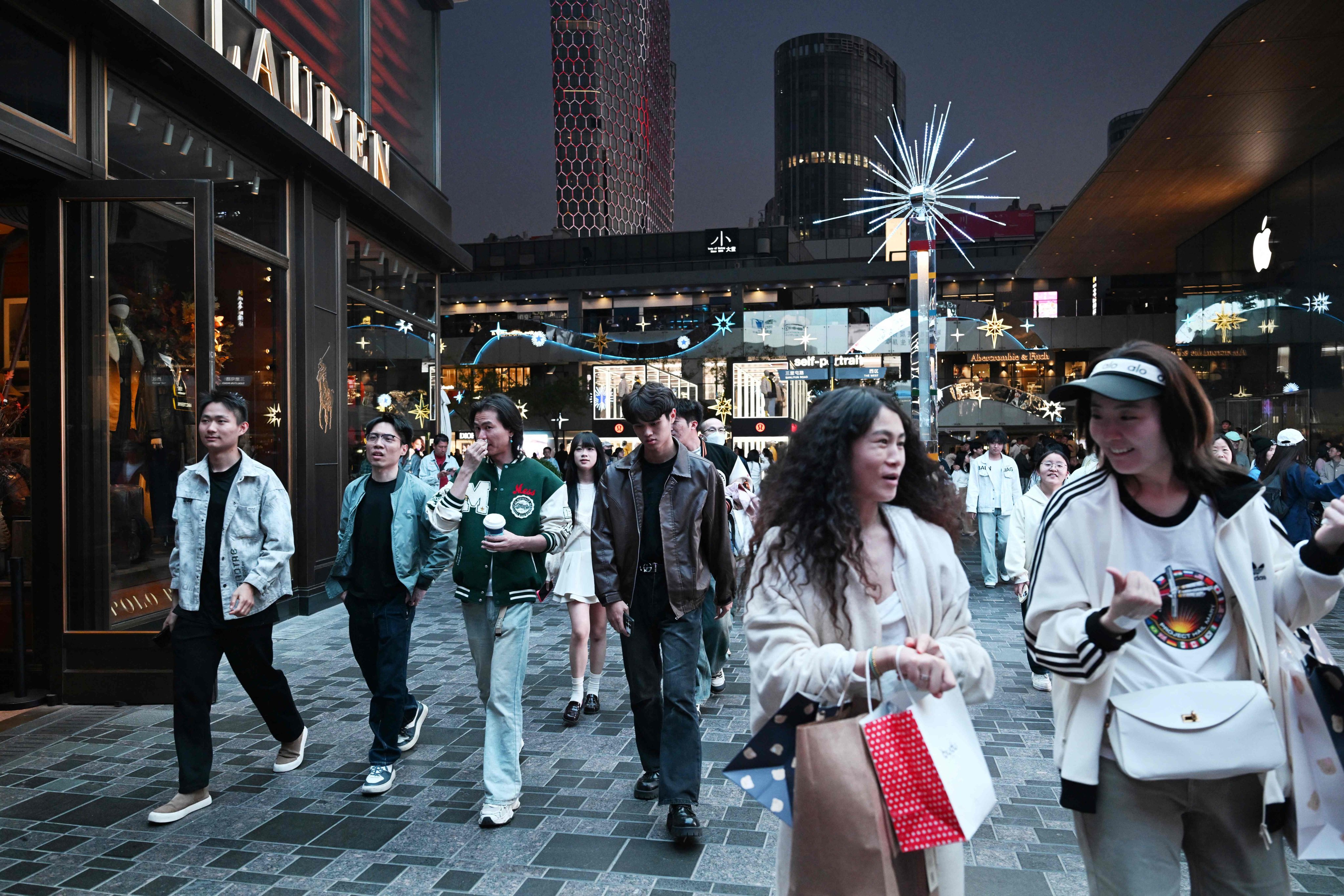 People walk through a shopping mall in Beijing. Photo: AFP