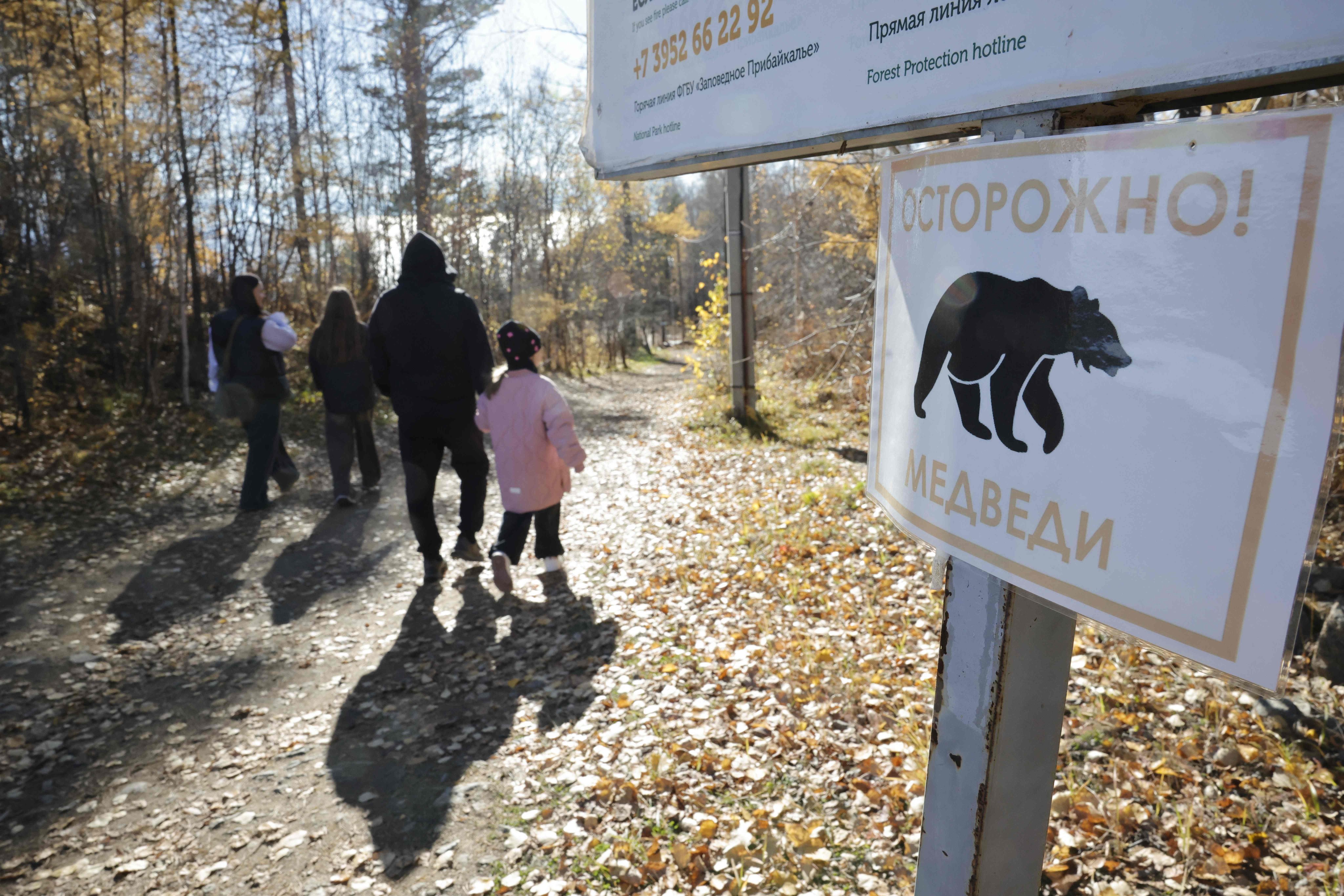 A sign warning hikers to beware of bears is seen on a trail in Russia’s Lake Baikal national park on October 9. Photo; AFP