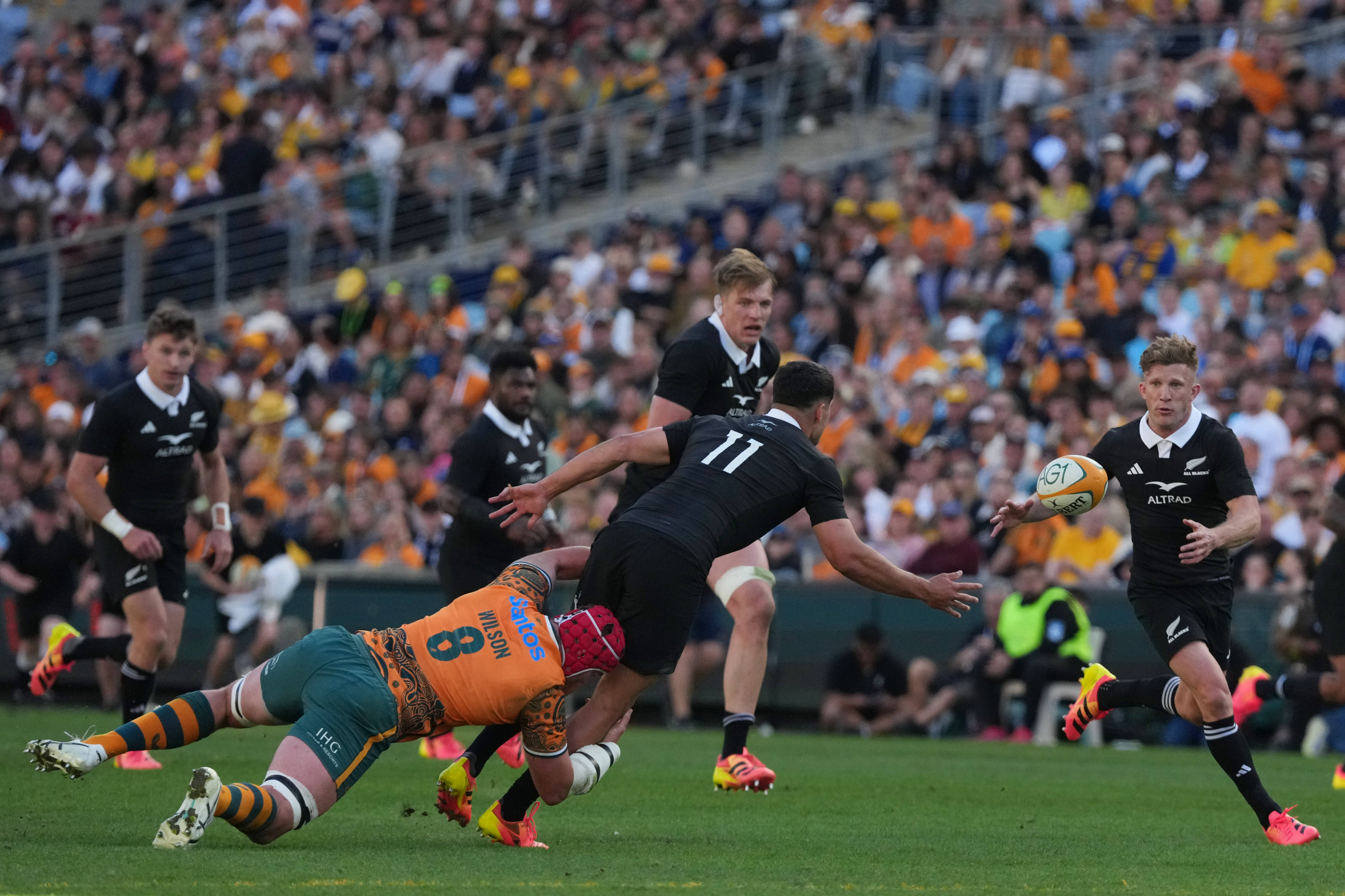 New Zealand winger Josh Moorby, who scored two tries, passes to flyhalf Damian McKenzie during their Bledisloe Cup win over Australia in Sydney on Saturday. Photo: AP