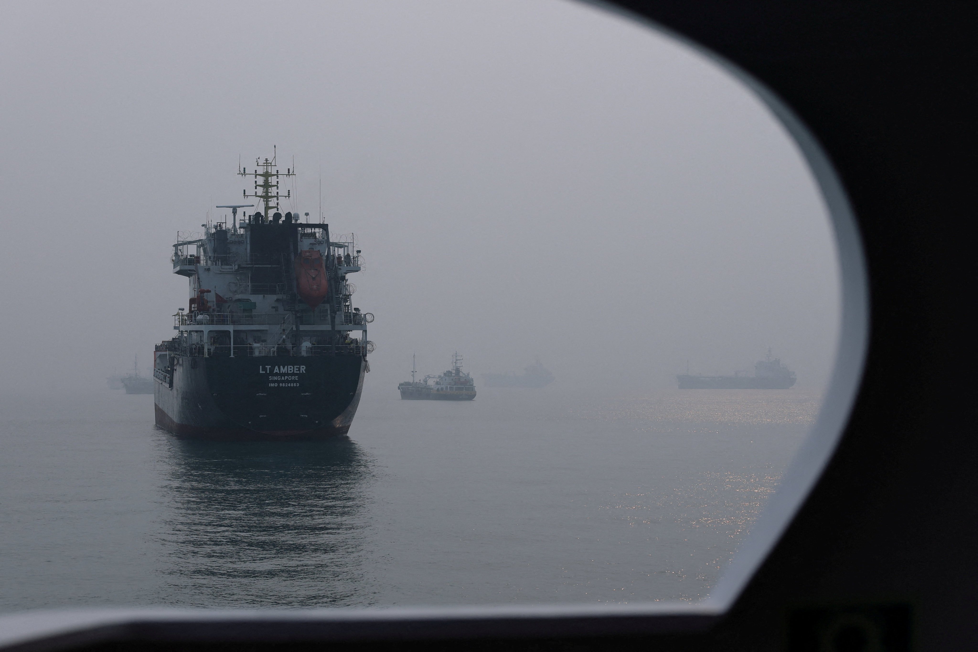 Haze shrouds vessels anchored in the eastern waters of Singapore on Friday. Photo: Reuters