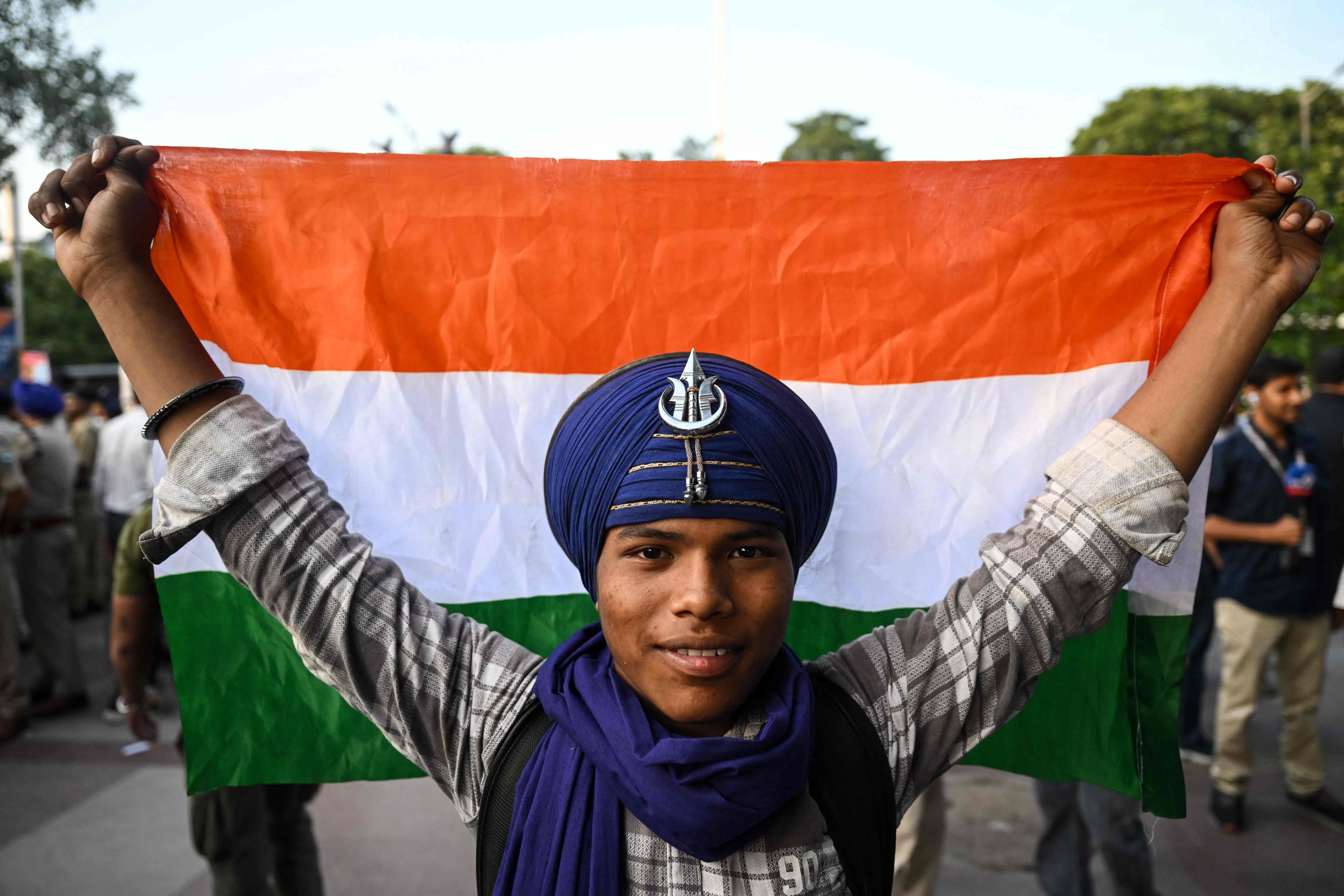 A Cockroach Janta Party supporter holds the country’s national flag during a protest at Connaught Place in Delhi on Friday. Photo: AFP